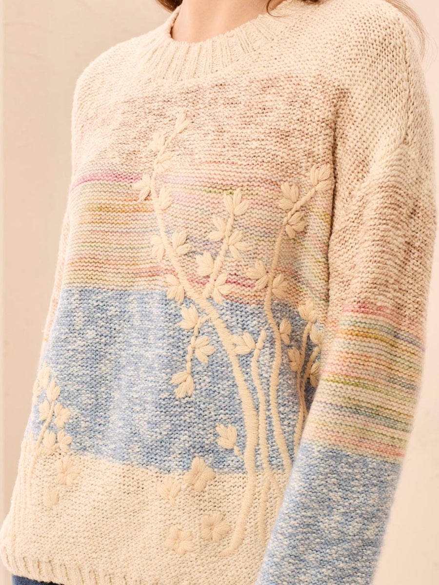 Cream knit sweater with pastel stripes and raised floral embroidery detailing on front and sleeves