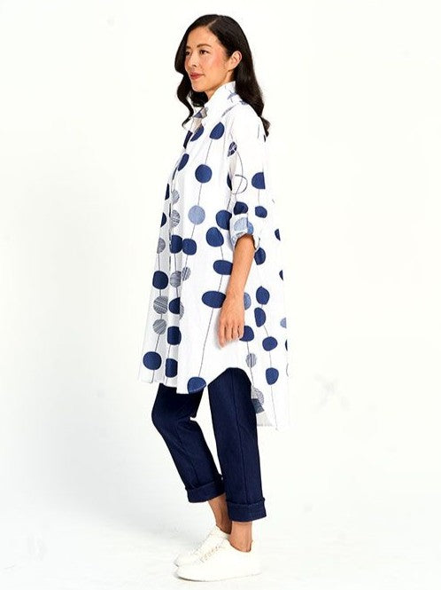 Side view of Multi Circle Cotton Button Front Tunic by Red Coral with navy circular patterns and white base fabric.