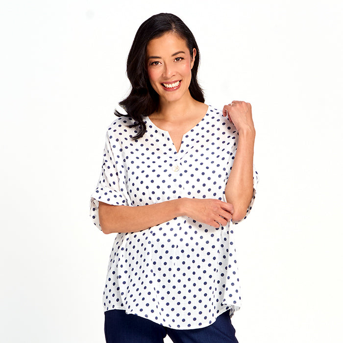White Polka Dot V-Neck Button Detail Blouse by Red Coral, styled as a lightweight casual top with navy dots.