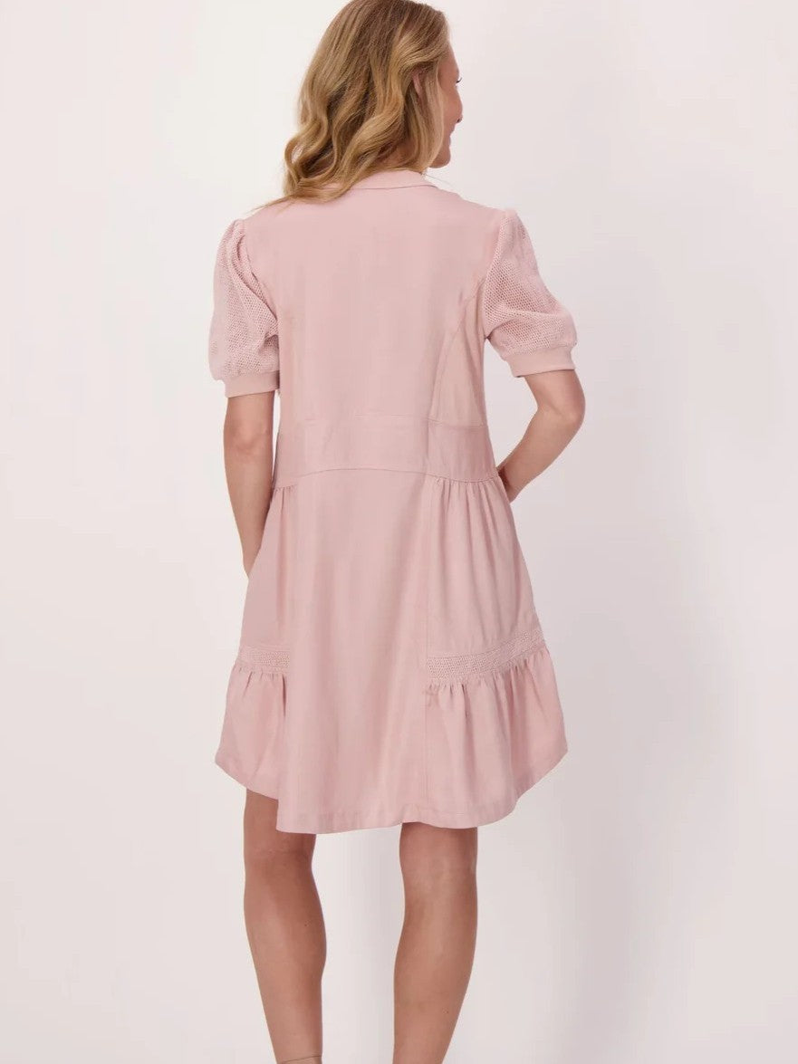 Light pink short-sleeve dress with puffed sleeves and gathered skirt detail viewed from the back.