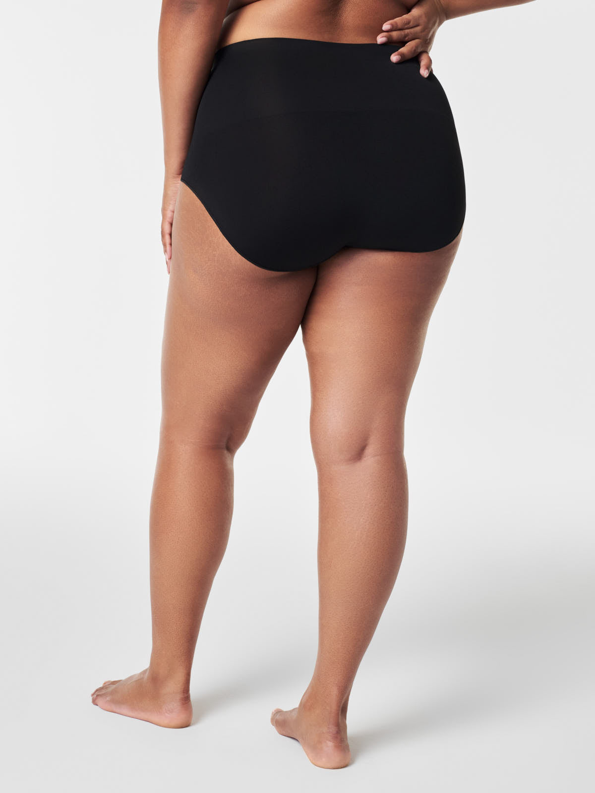 Black seamless brief underwear by Spanx from the back, showcasing the SPANX EcoCare Seamless Brief design.