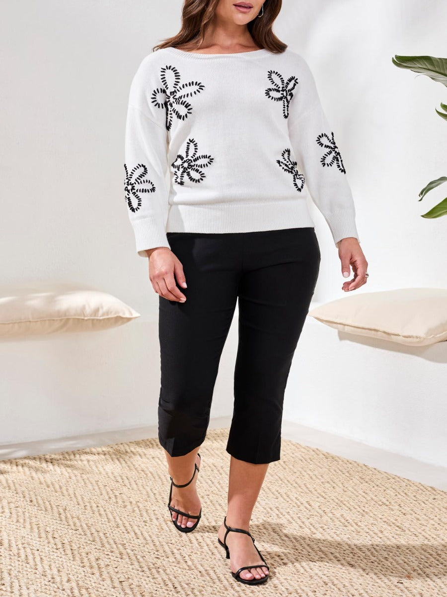 Tribal Flatten It® Slimming 22" Capri Pants in black by Tribal Sportswear Inc., styled with a white patterned sweater.