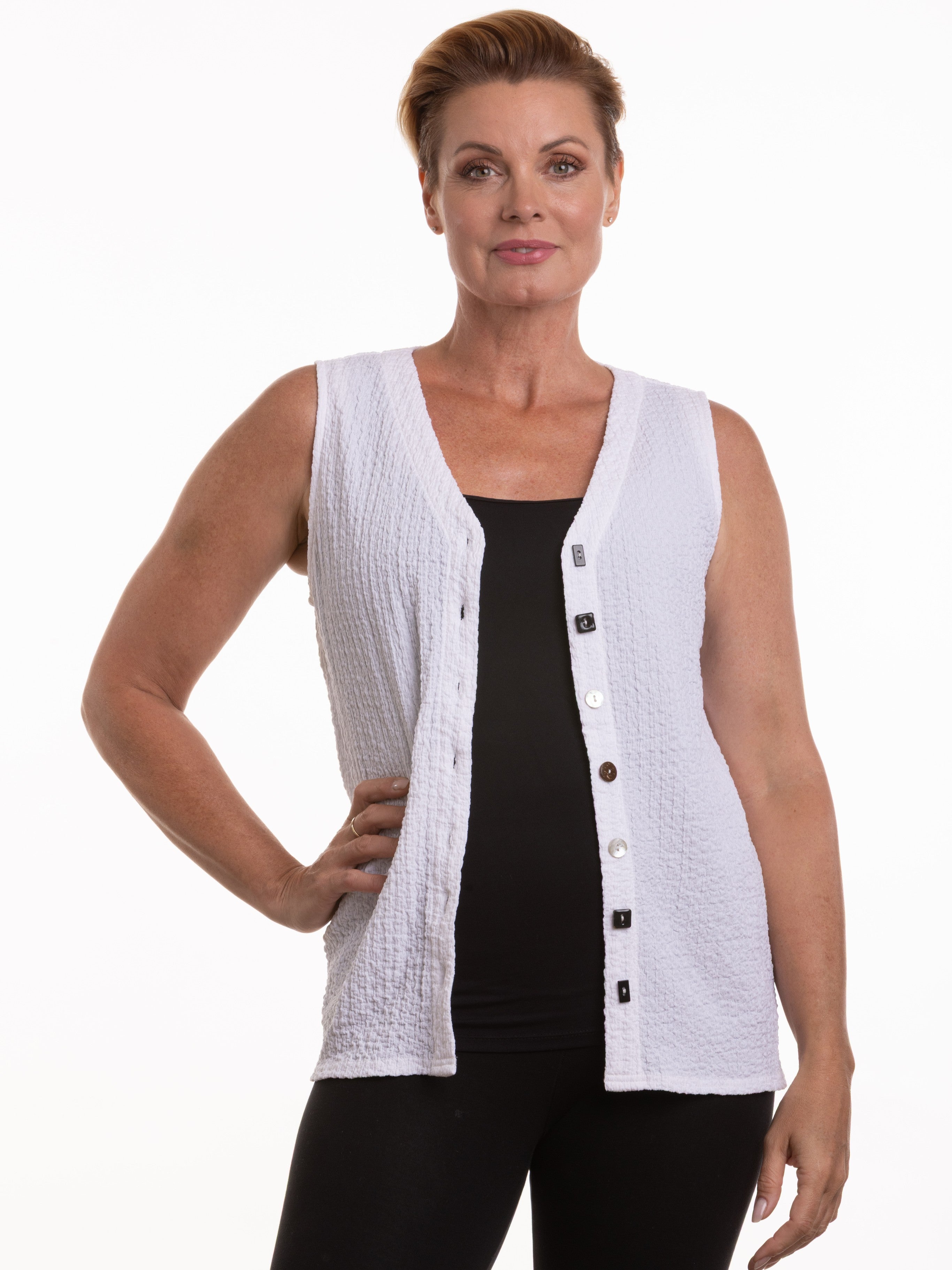 White textured Mixed Button Seersucker Sleeveless Top by Nulook Fashions over a black base layer.