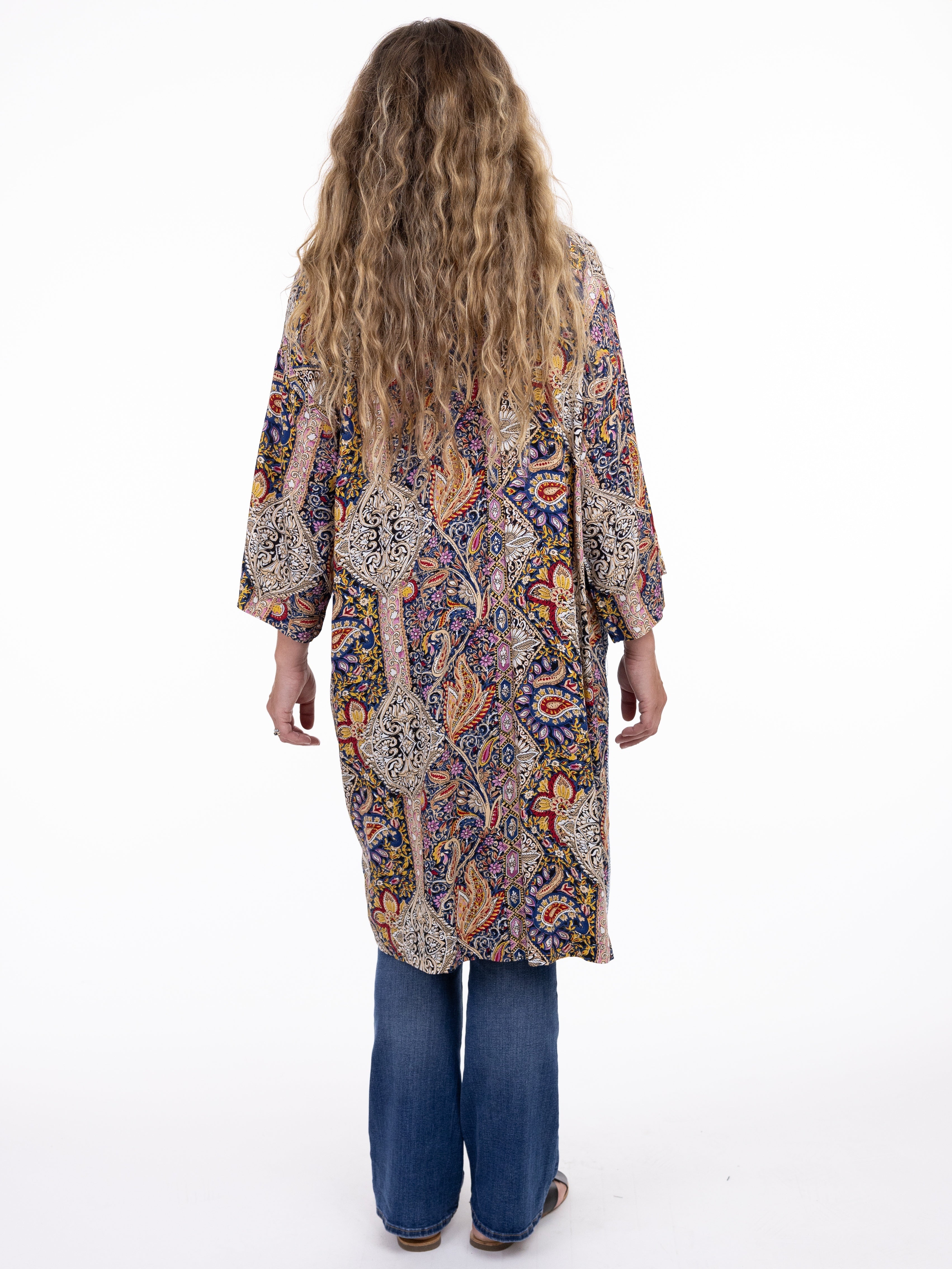 Back view of Shannon Passero Janis Denim Trim Cardigan with vibrant patterns paired with denim jeans by SHANNON PASSERO INC