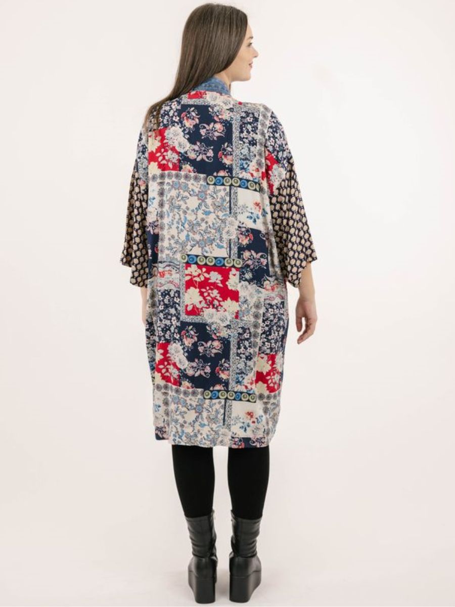 Long patchwork floral and geometric patterned outerwear jacket with wide sleeves in navy, red, and beige tones