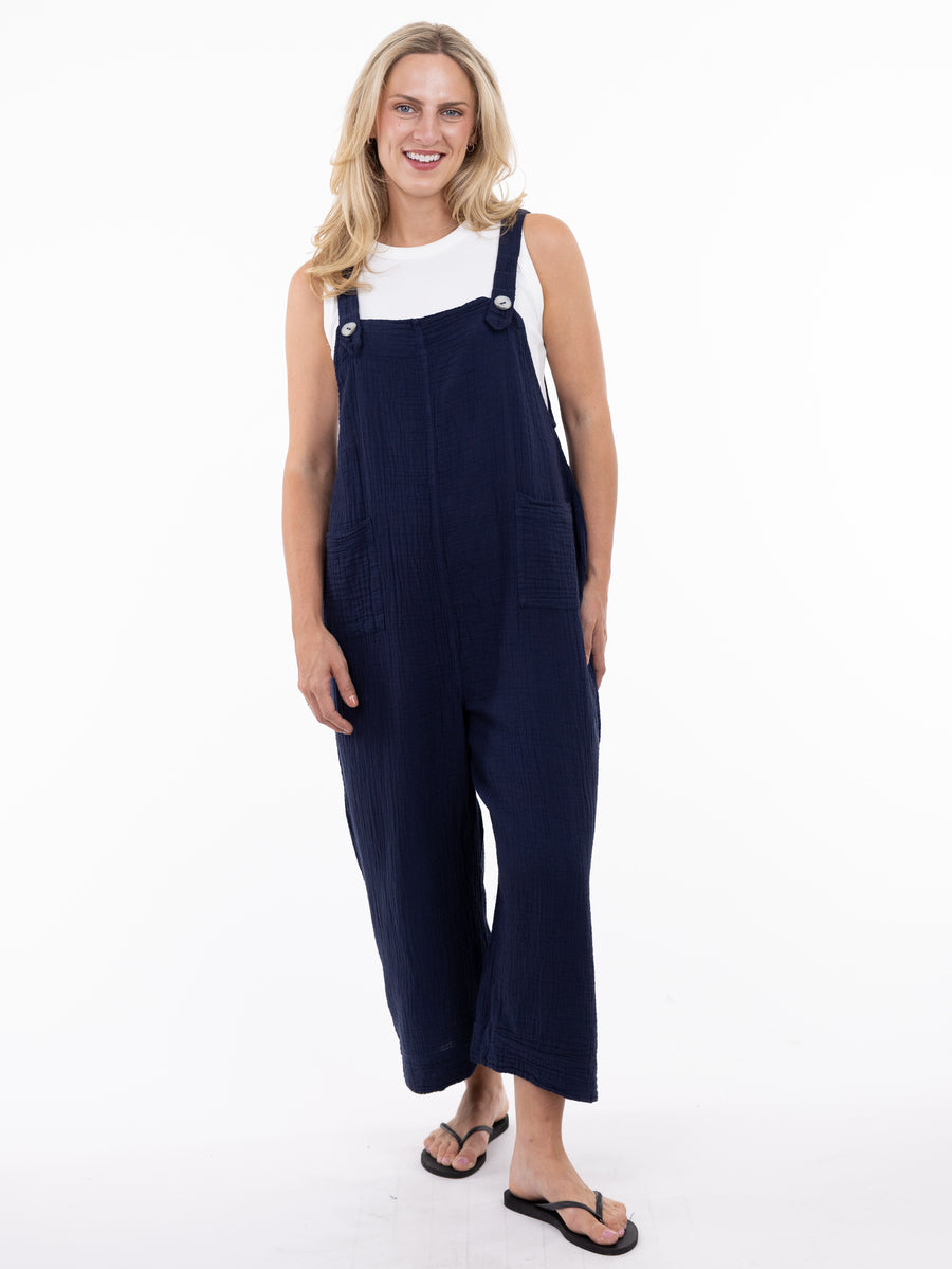 Model in navy Shannon Passero Grace Cotton Gauze Pocket Overalls by SHANNON PASSERO INC with white top and sandals