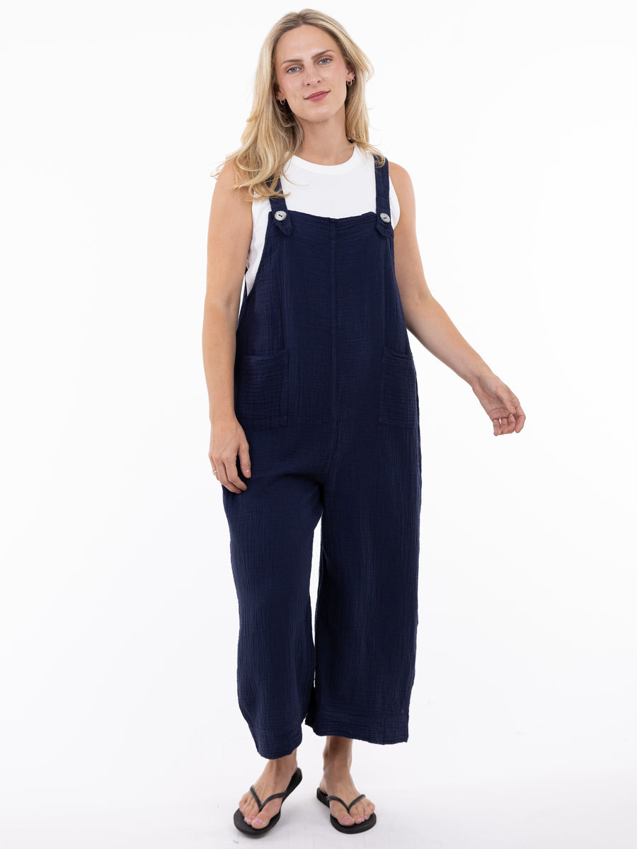 Model wears navy Shannon Passero Grace Cotton Gauze Pocket Overalls by SHANNON PASSERO INC with white sleeveless top.