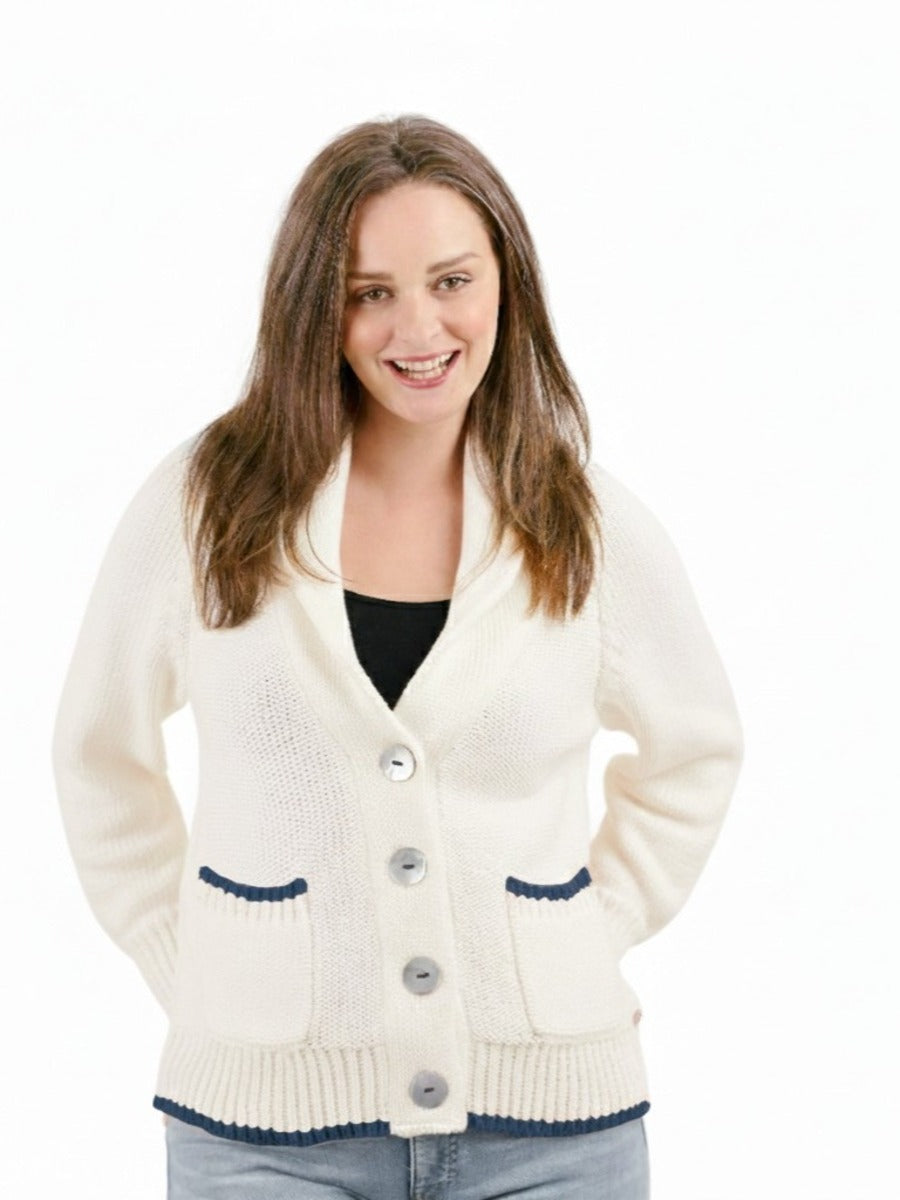 Smiling model in cream Shannon Passero Seaside Sailing Cardigan with dark trim, showcasing cozy knit sweater by SHANNON PASSERO INC