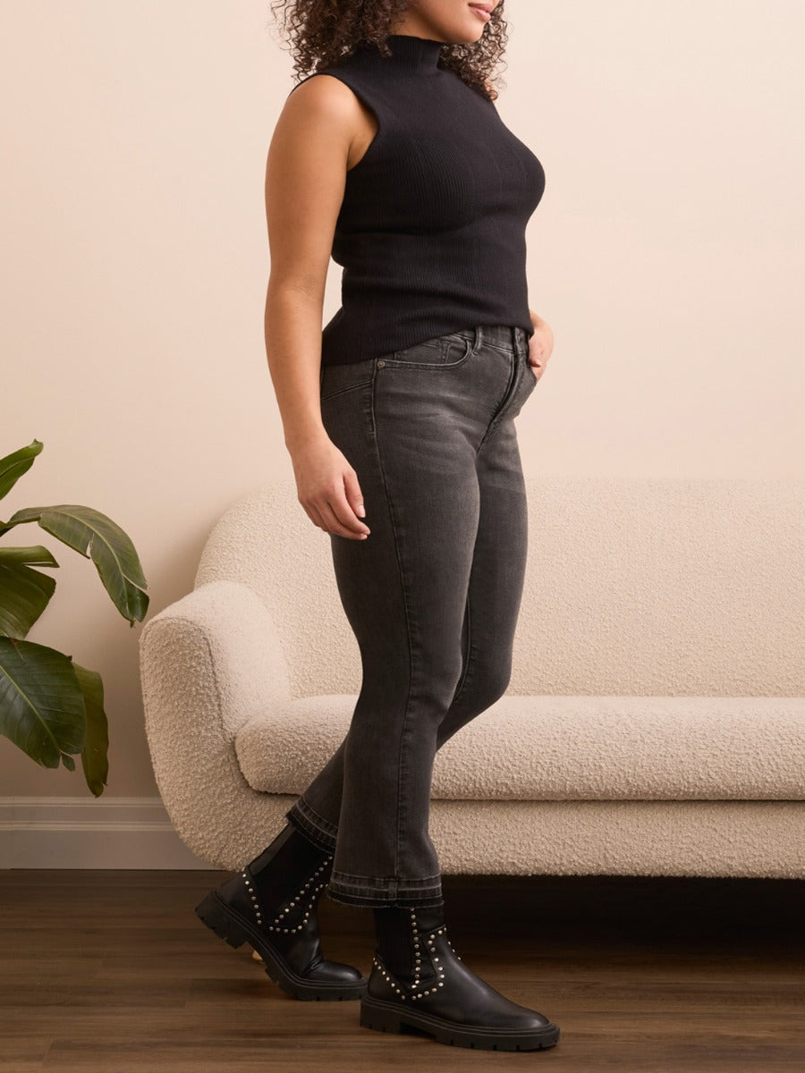 Side view of black Tribal Sophia Flare 26" Denim Pants styled with black sleeveless top and studded boots by Tribal Sportswear Inc.