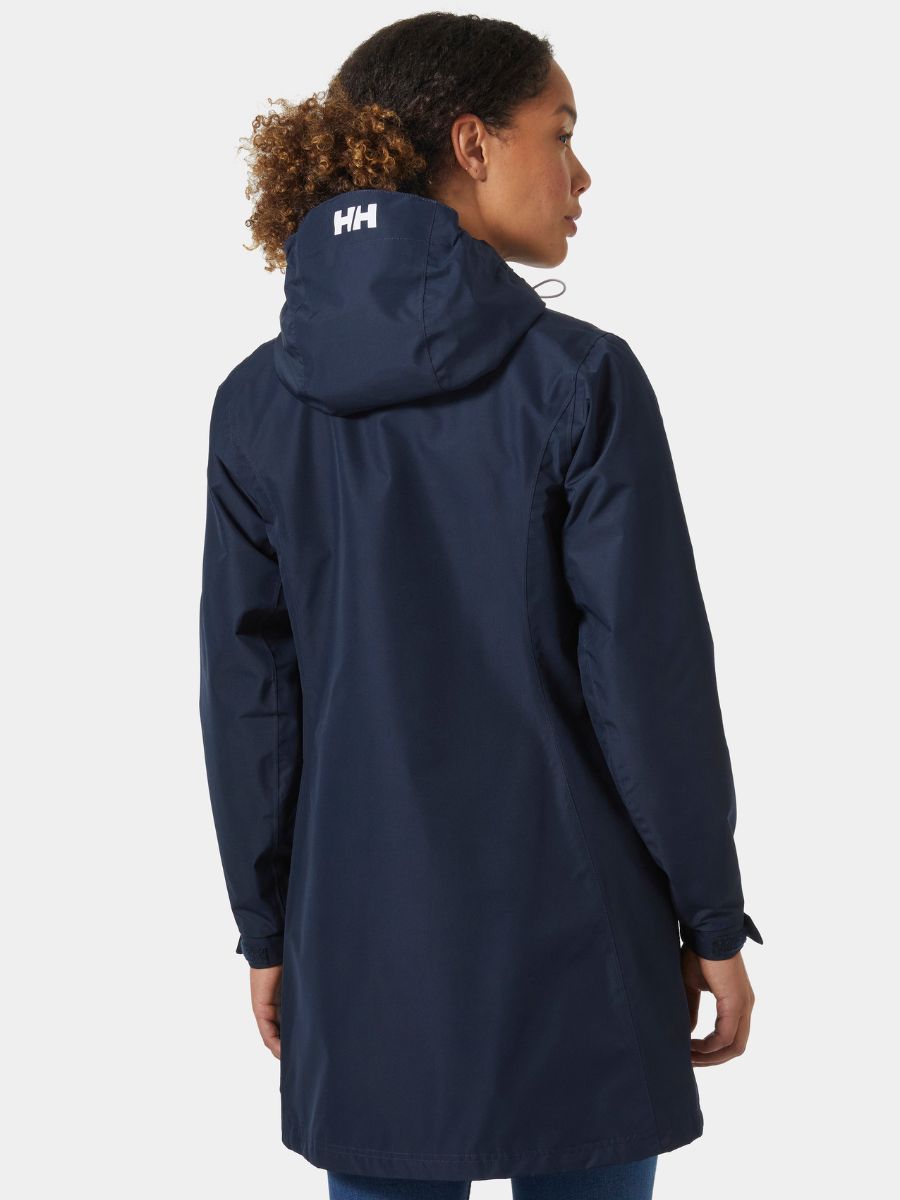 Back view of a navy blue hooded jacket with a white logo on the hood, worn over blue jeans.