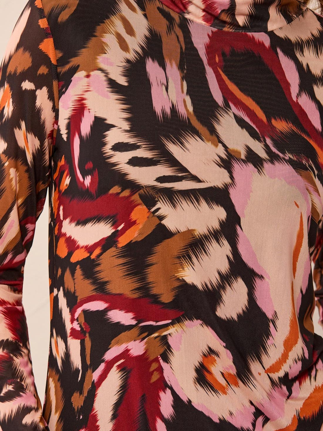 Close-up of a multicolored abstract animal print pattern on a long-sleeve fabric top