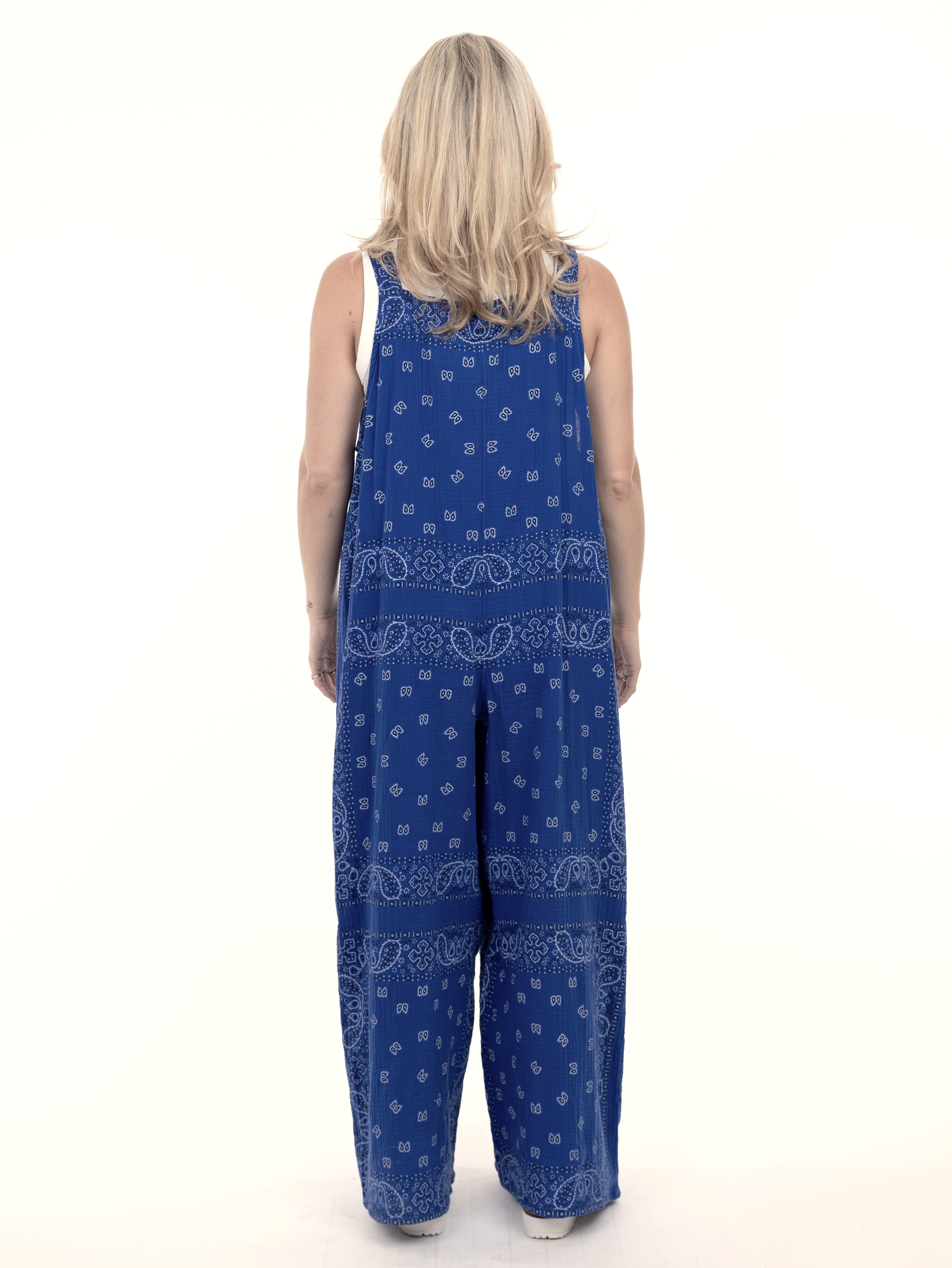 Back view of Shannon Passero Bandana Overalls in blue with paisley print by SHANNON PASSERO INC