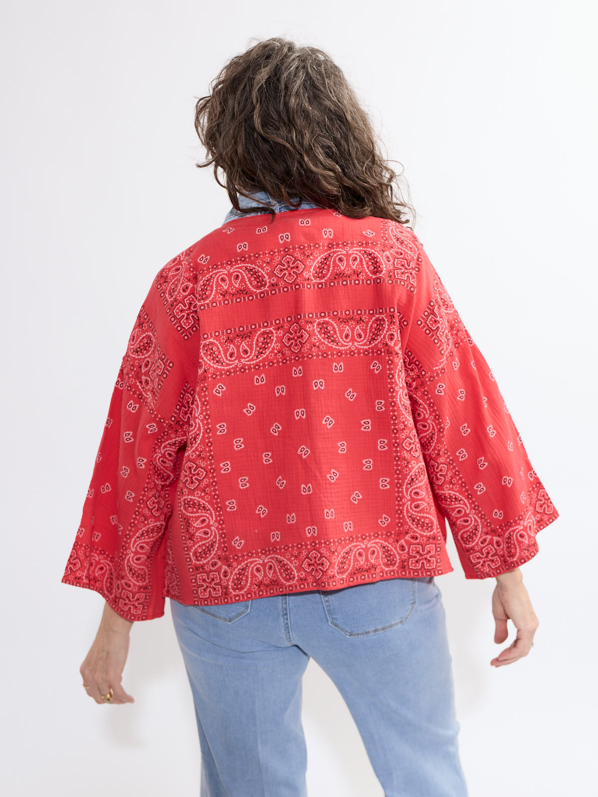 Red bandana print Shannon Passero Bandana Short Kimono outerwear from SHANNON PASSERO INC, styled with casual denim jeans.