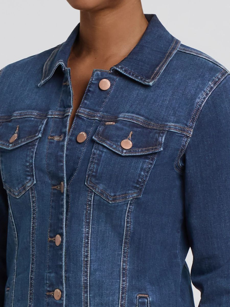 Dark blue denim jacket with copper buttons and chest flap pockets on plain background