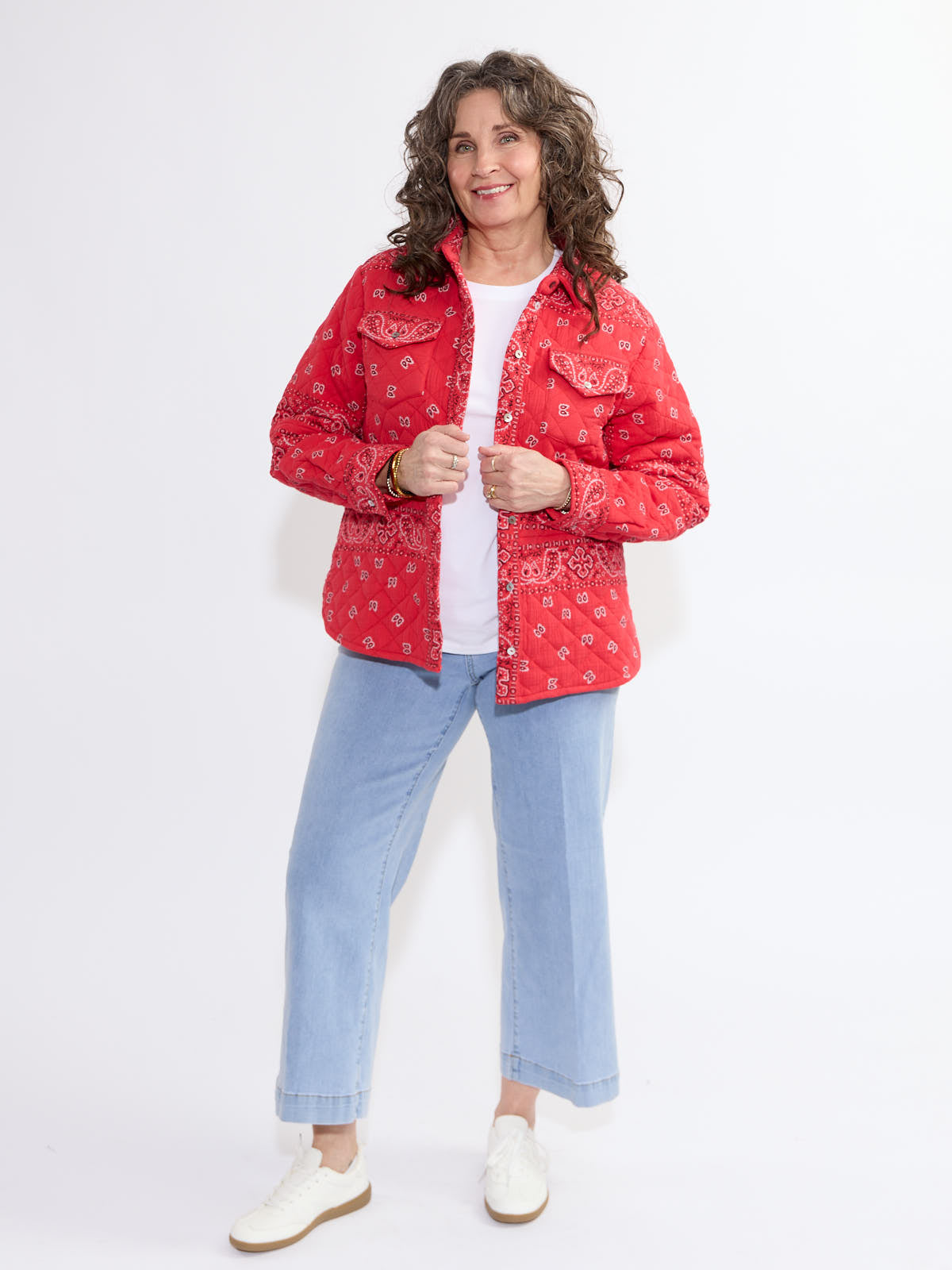 Red paisley patterned Shannon Passero Bandana Quilted Shacket from SHANNON PASSERO INC styled with light denim jeans and white shoes