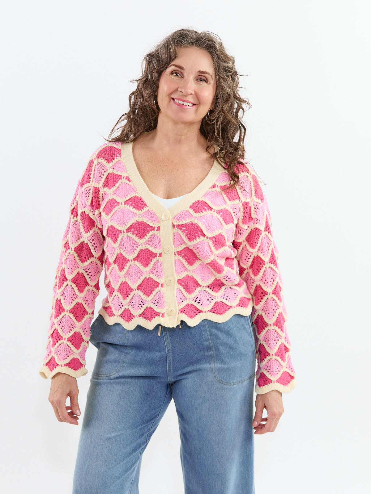 Smiling model wearing Razzle Dazzle Scallop Crochet V-Neck Button Cardigan in pink outerwear sweater style