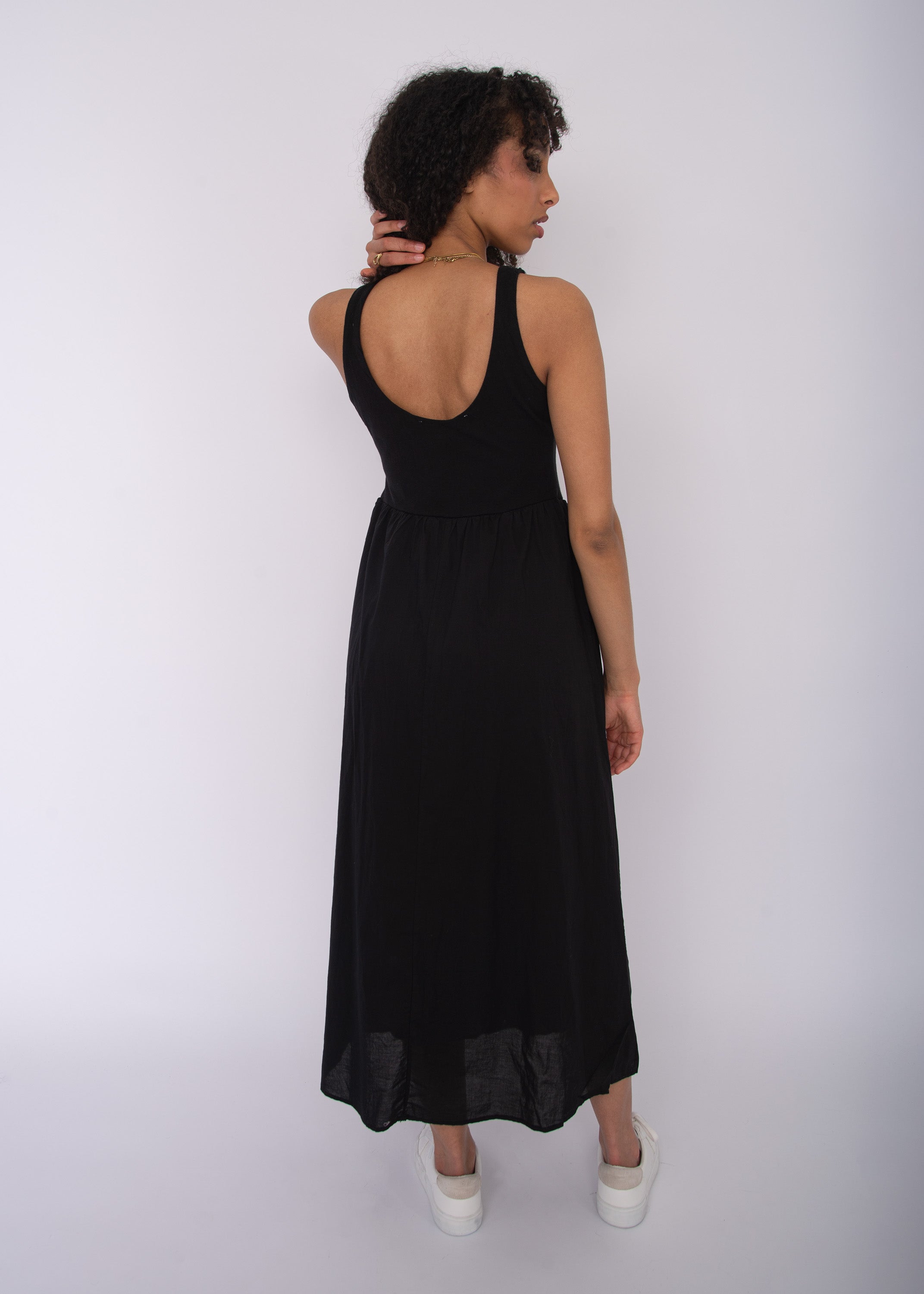 Back view of Voila Combo Sleeveless Maxi Dress in black by Class Couture with scoop back and long flowing skirt.