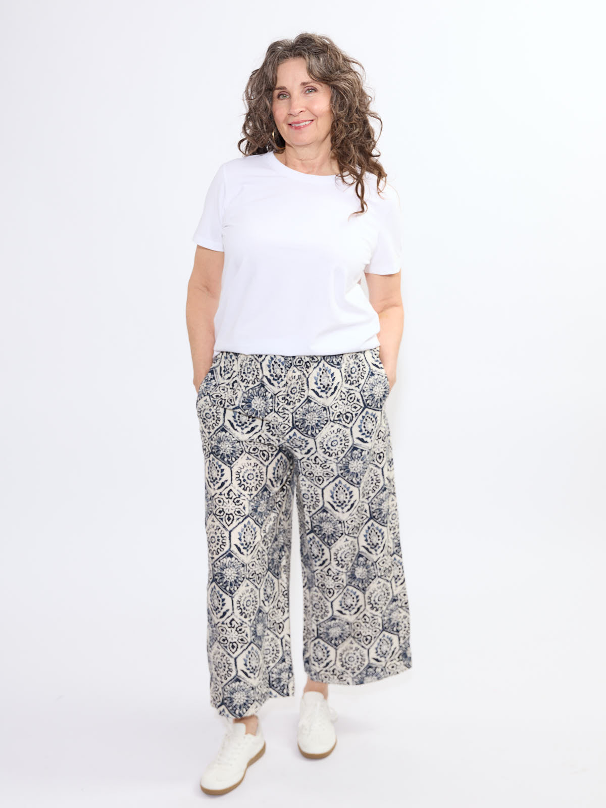 Model wearing patterned wide-leg Shannon Passero Ellie Palms PO Crop Pant with white t-shirt by SHANNON PASSERO INC