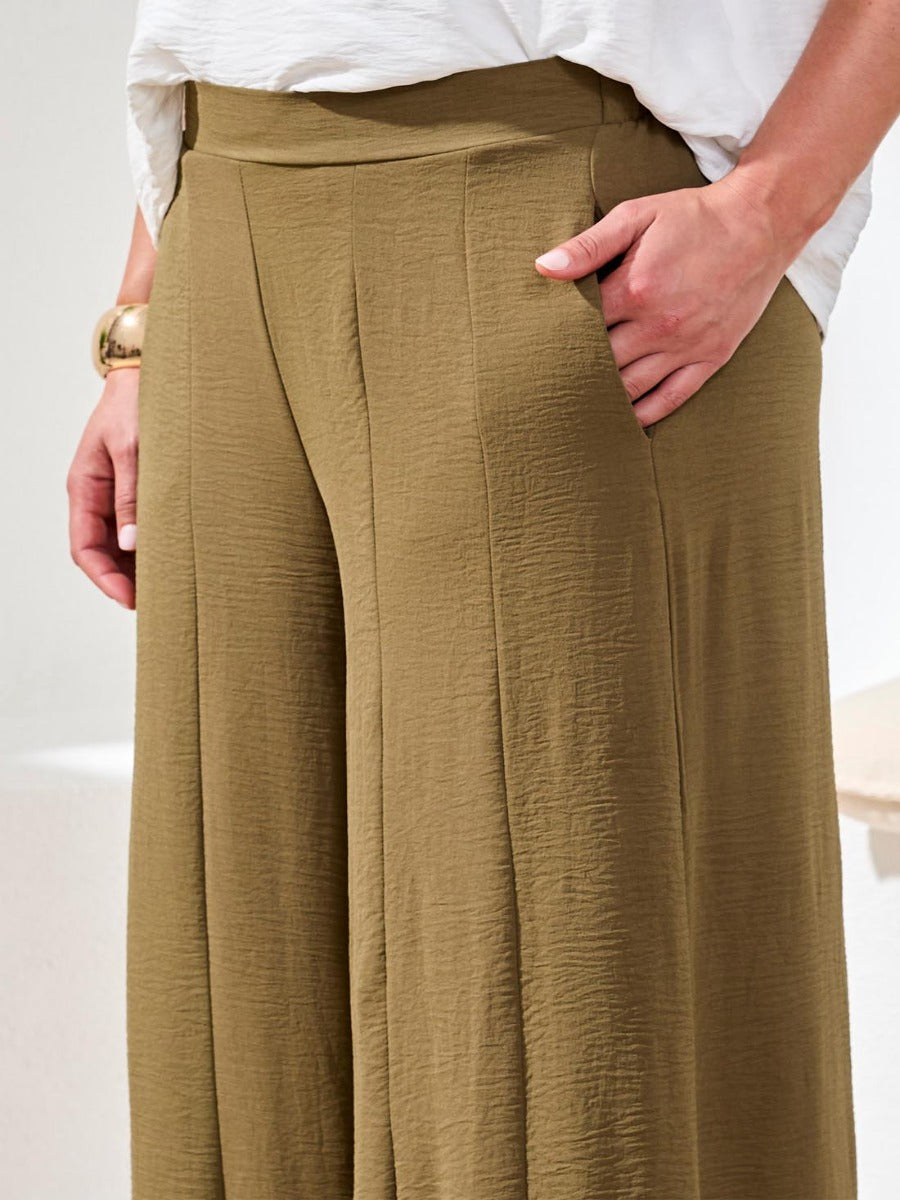 Olive green Tribal Lush Oasis Airflow Wide-Leg Pants from Tribal Sportswear Inc. with textured fabric and side pockets.
