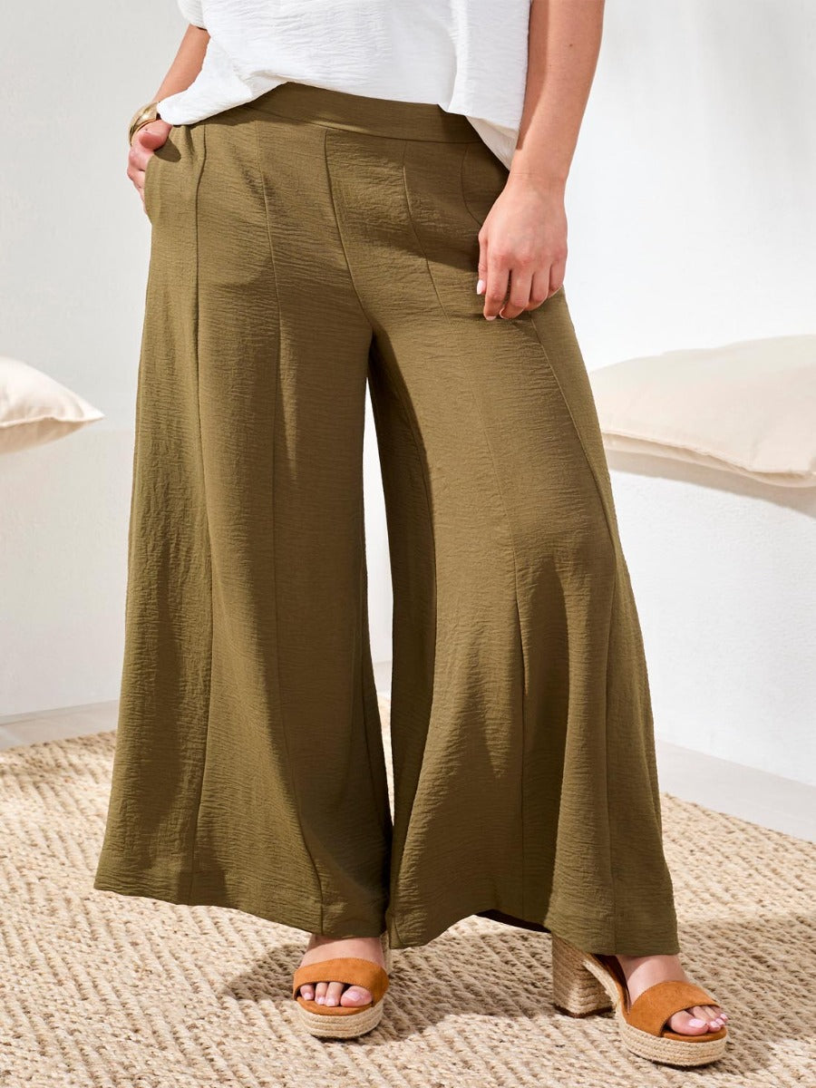 Olive green Tribal Lush Oasis Airflow Wide-Leg Pants by Tribal Sportswear Inc. styled with tan sandals.