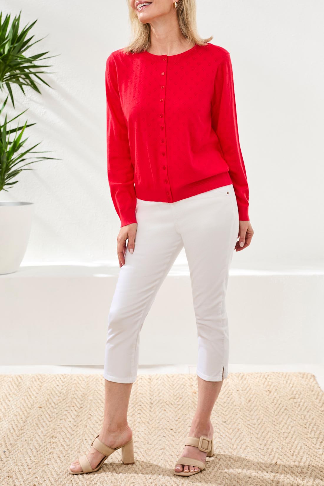 Tribal Playful Heart Pointelle Crew Cardigan in red by Tribal Sportswear Inc., styled with white cropped pants and beige heels