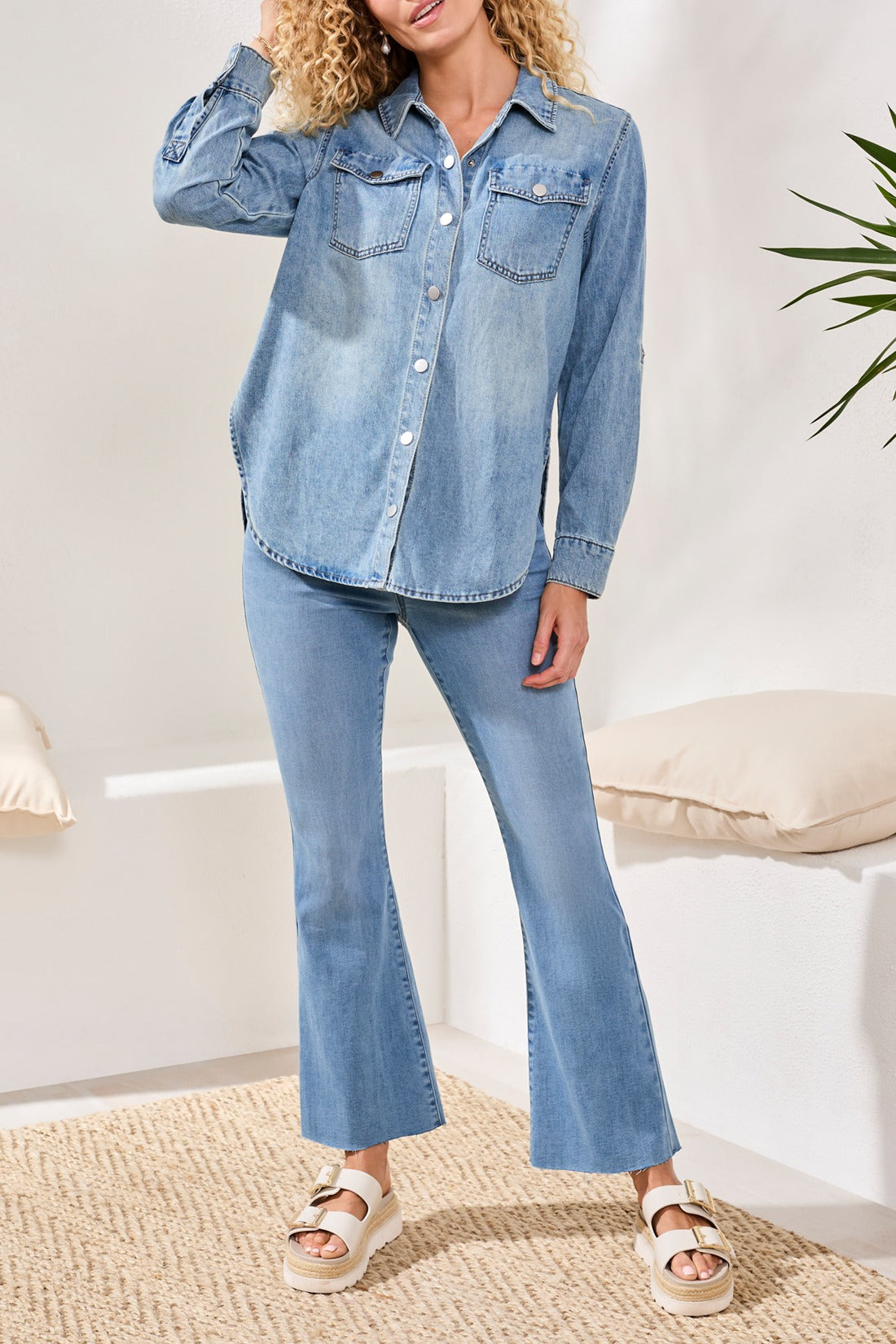 Tribal Lush Oasis Long Sleeve Denim Shirt from Tribal Sportswear Inc. styled with light denim pants and sandals.