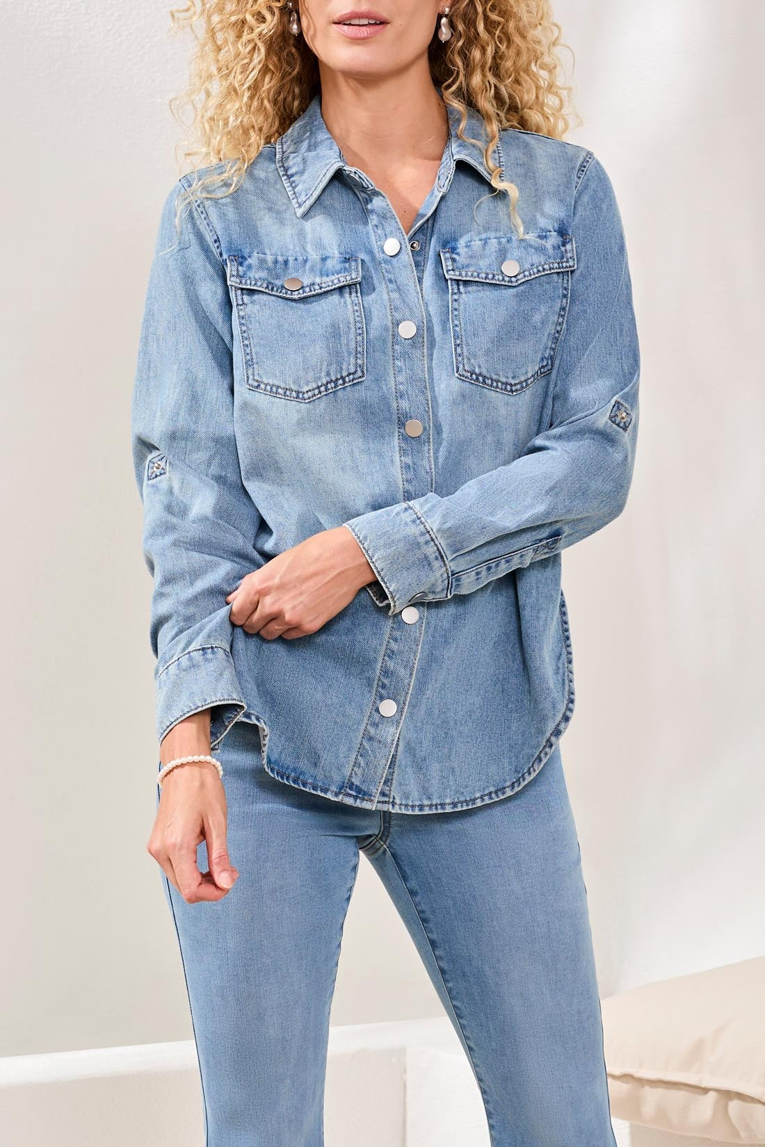 Light blue denim Tribal Lush Oasis Long Sleeve Denim Shirt by Tribal Sportswear Inc. with front pockets and button closure