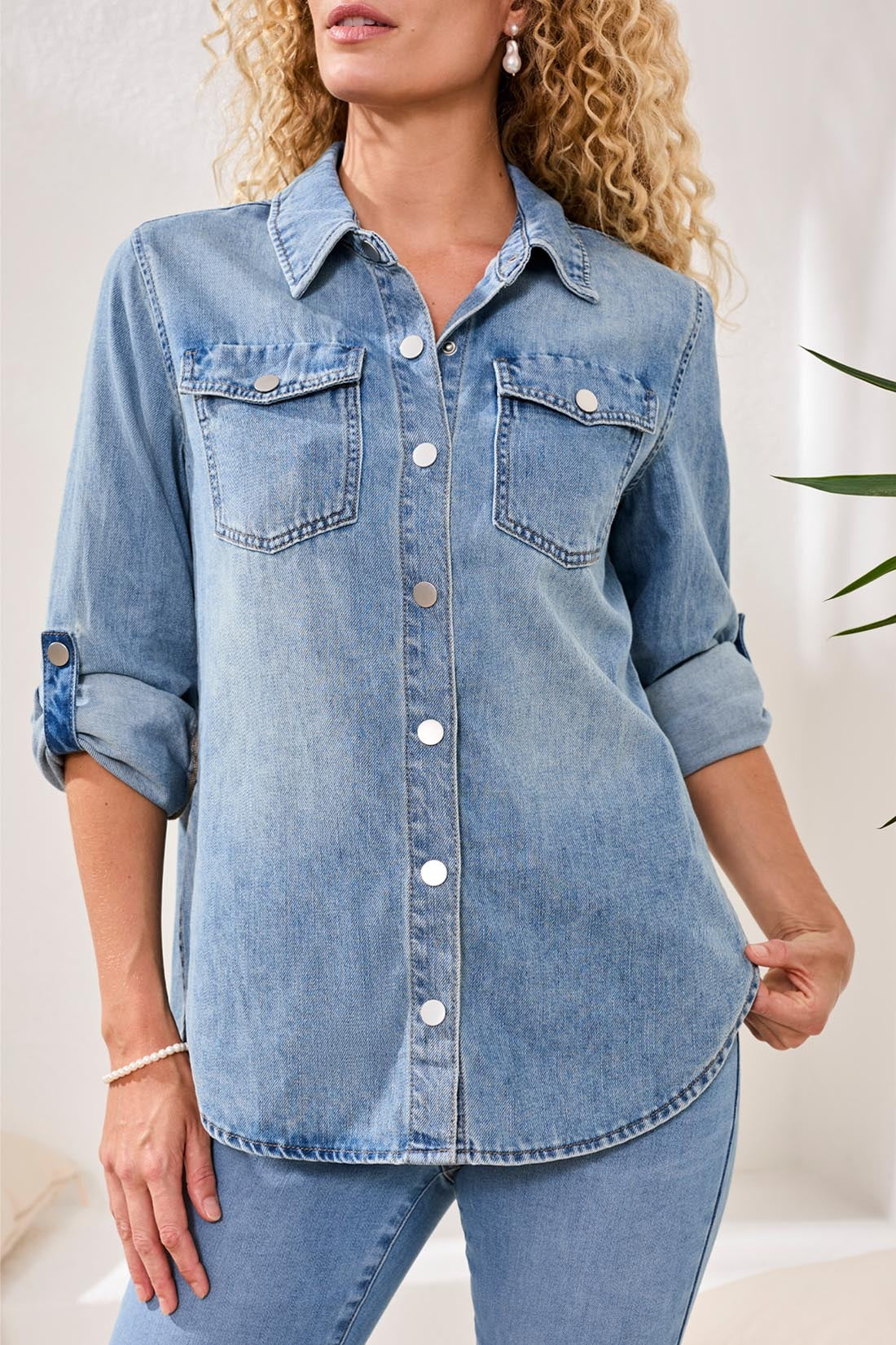 Light blue Tribal Lush Oasis Long Sleeve Denim Shirt by Tribal Sportswear Inc. with rolled sleeves and chest pockets.