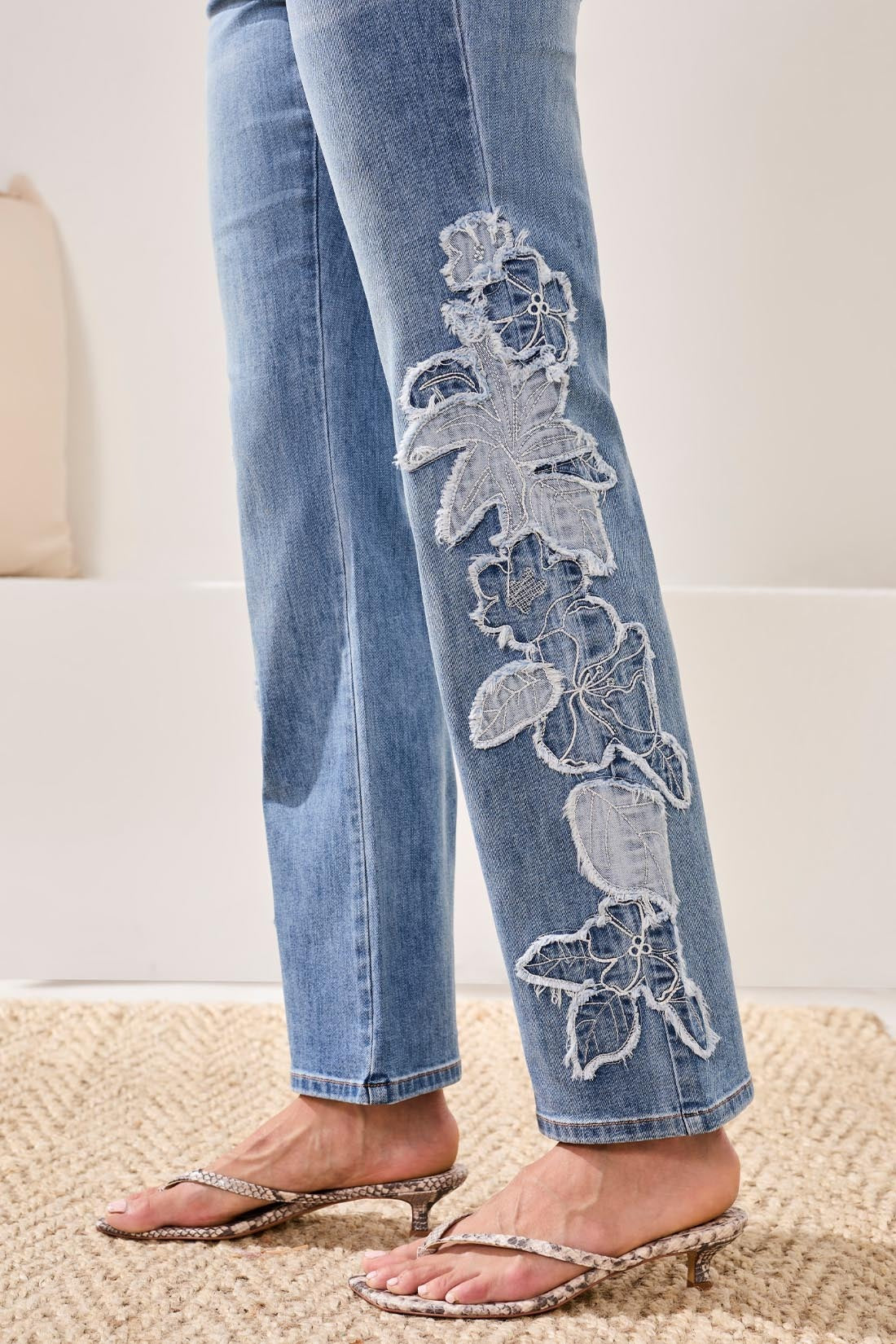 Light blue denim close-up featuring floral embroidery on Tribal Lush Oasis Sophia Floral 31" Jeans by Tribal Sportswear Inc.