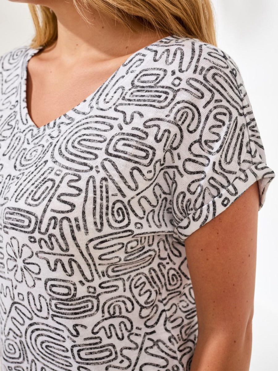 Close-up of Tribal Wear-Me-Two-Ways Printed Short Sleeve Top by Tribal Sportswear Inc. with black and white print pattern.