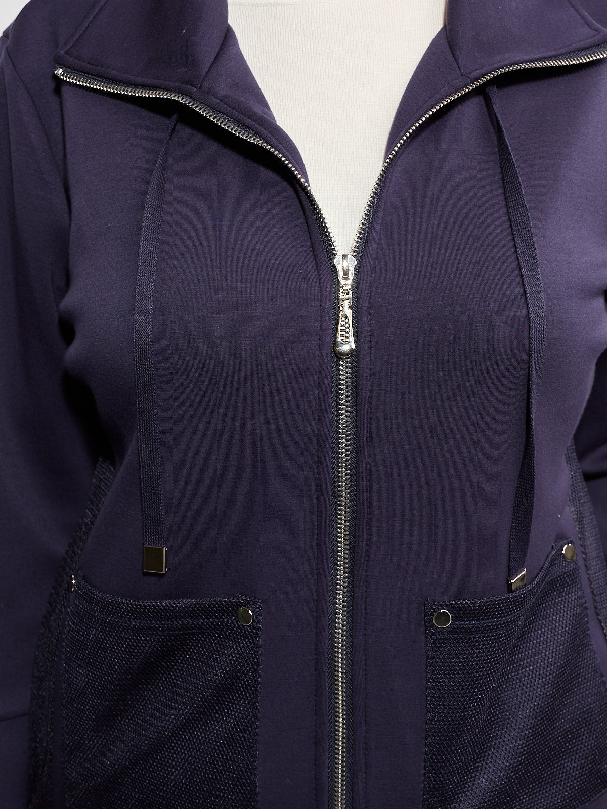Navy blue zip-up jacket with drawstrings and textured front pockets on a neutral background.