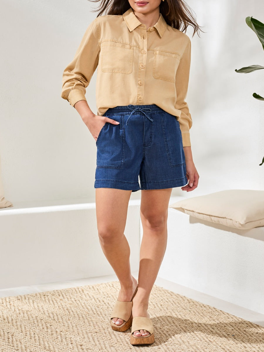 Tribal Audrey Tie-Waist 6" Shorts in denim by Tribal Sportswear Inc. styled with a beige button-up shirt and sandals.