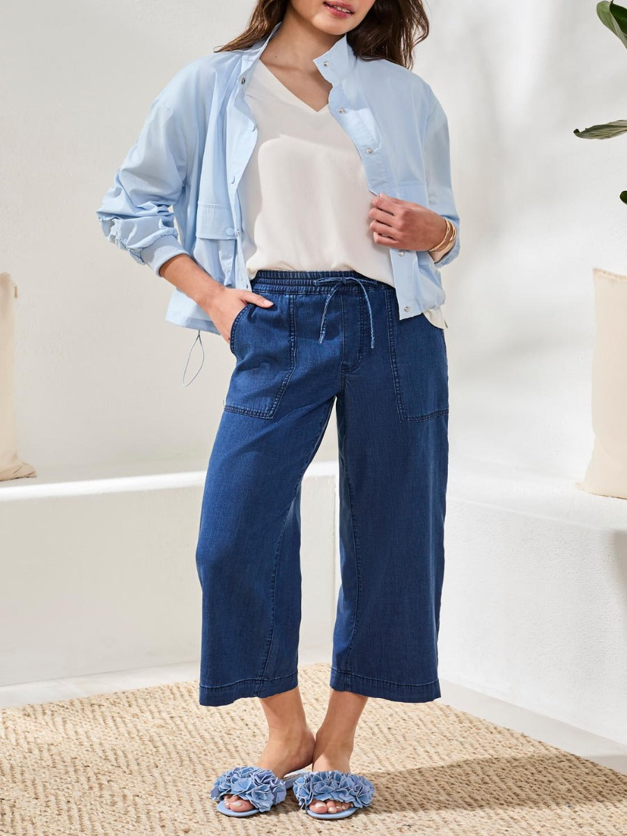 Blue denim Tribal Audrey Tie-Waist 25" Wide-Leg Pants by Tribal Sportswear Inc. styled with light jacket and cream top.