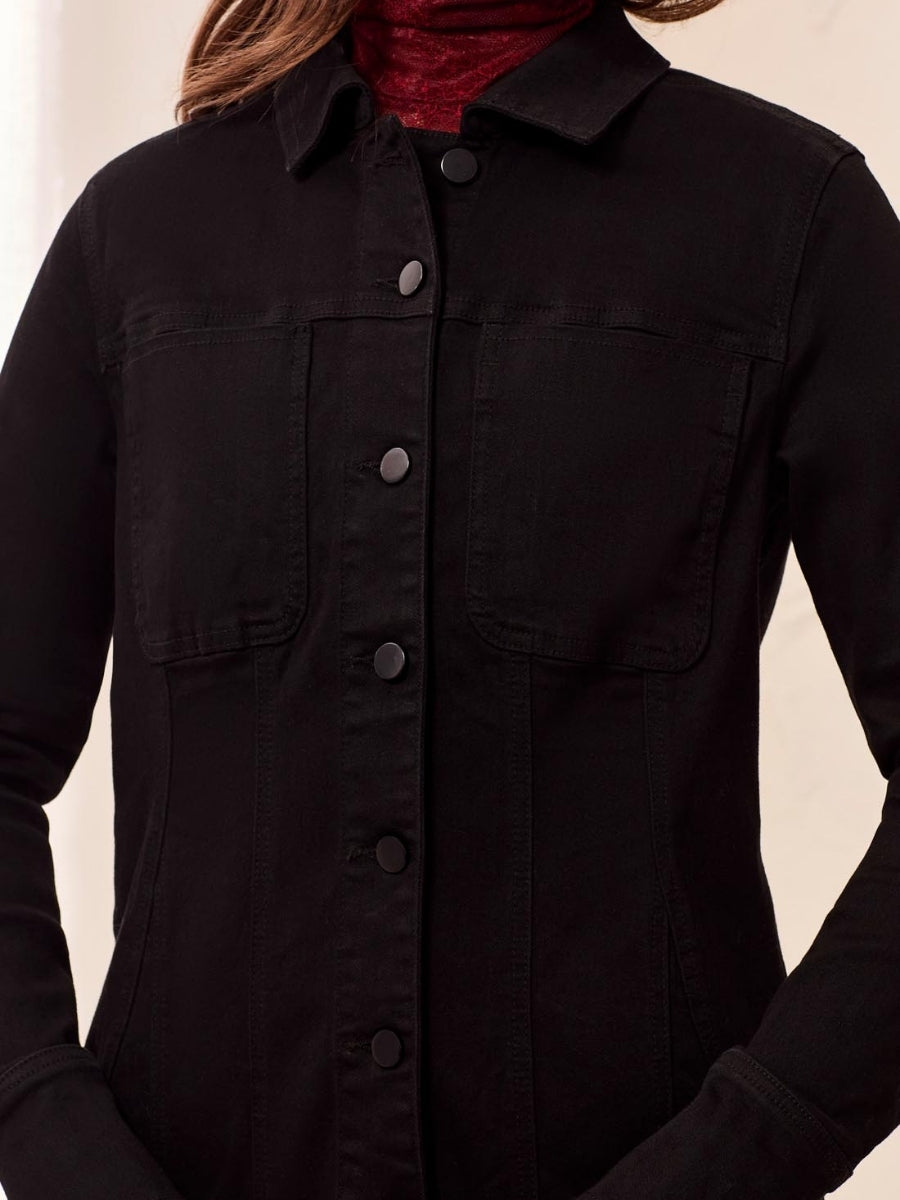 Black button-up denim jacket with chest pockets layered over a dark red turtleneck sweater.