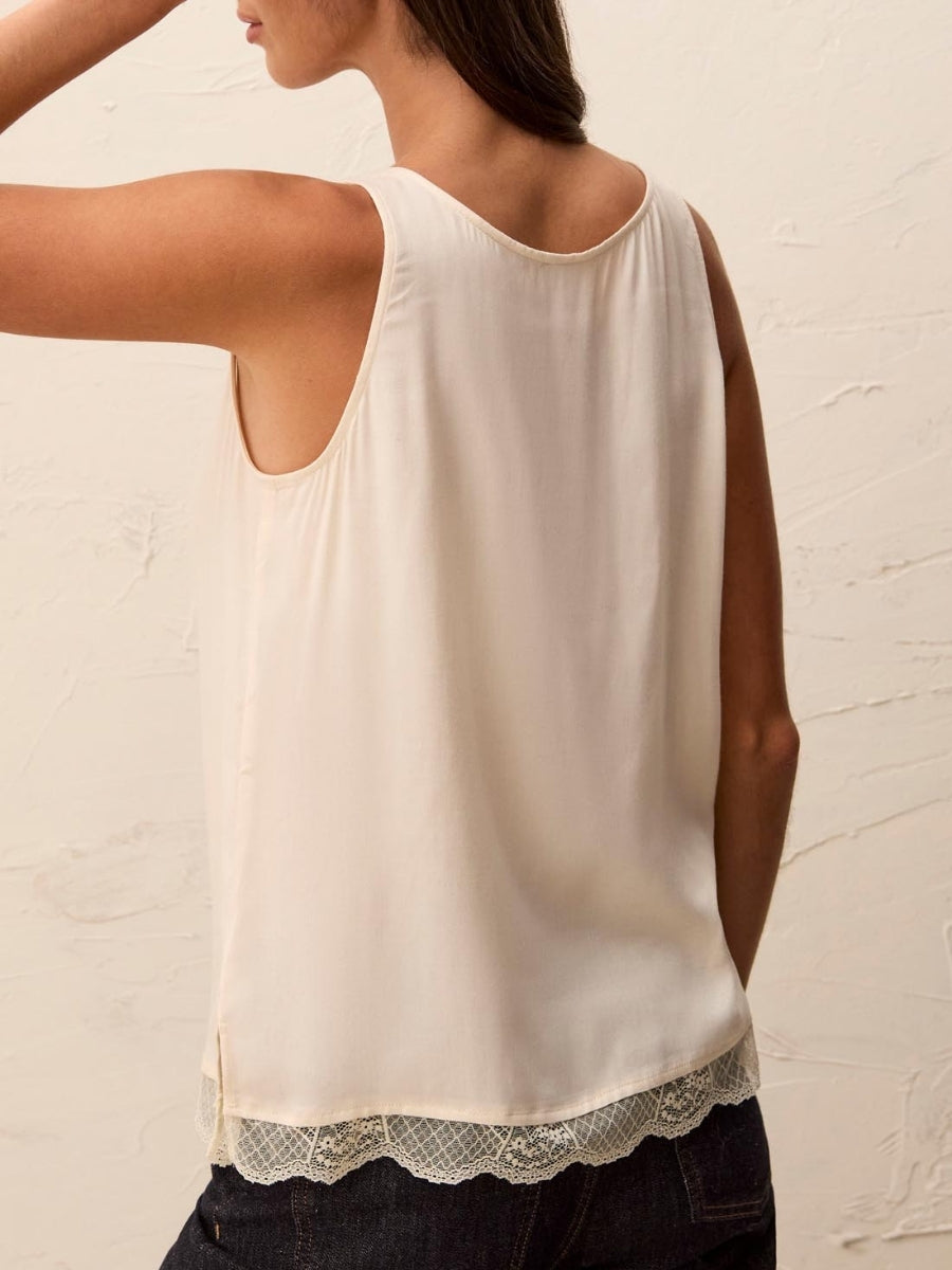 Back view of white Tribal Essential Lace Camisole Top with lace hem by Tribal Sportswear Inc. paired with dark denim jeans.