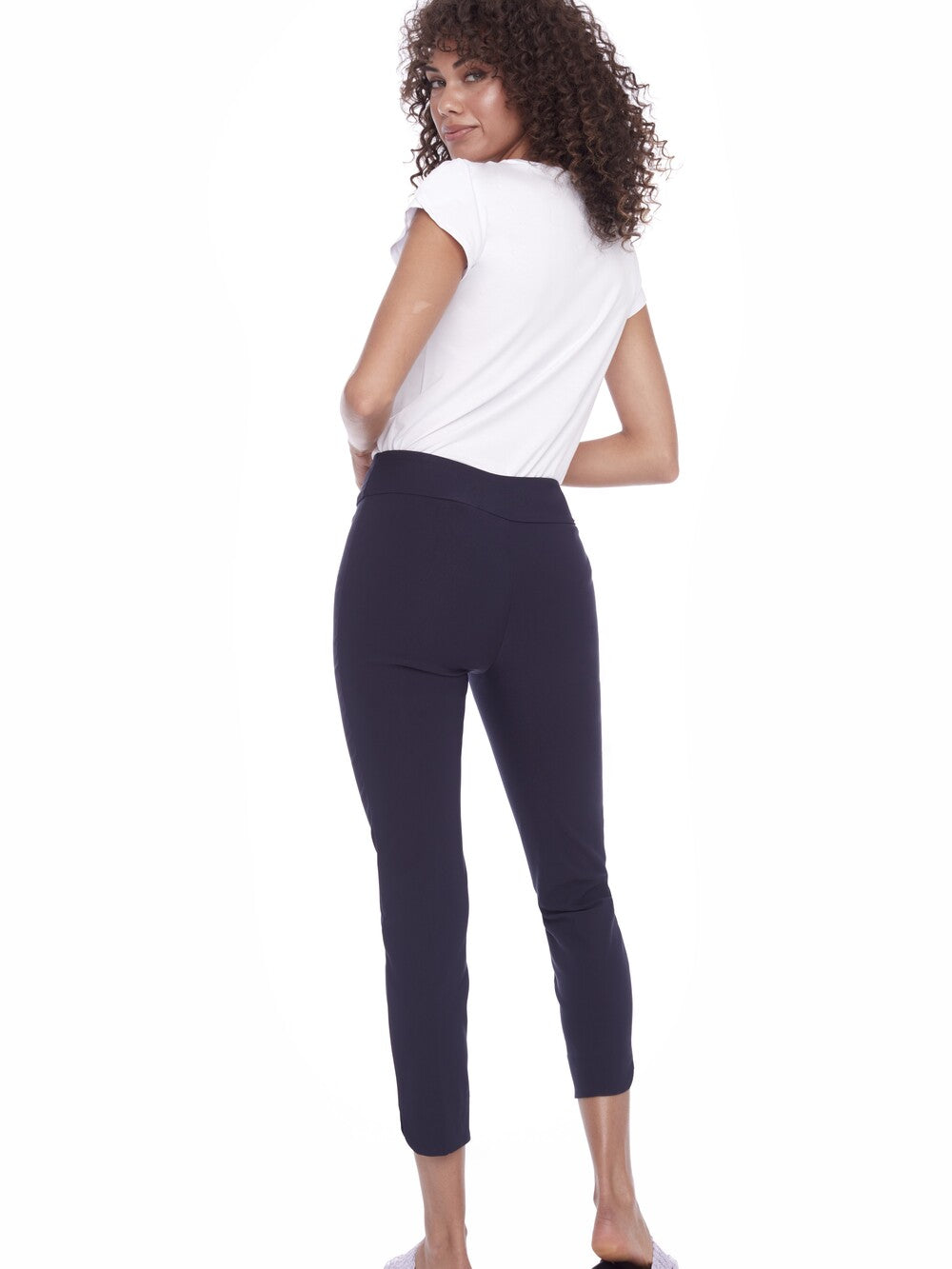 Model showcasing Up UP Solid Wrap 28" Petal Slim Pant in navy, paired with a white short-sleeve top