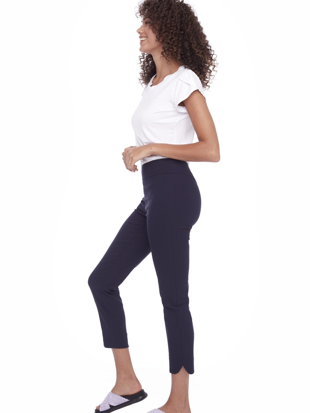 Up Solid Wrap 28" Petal Slim Pant in navy by Up shown with a casual white top and sandals.