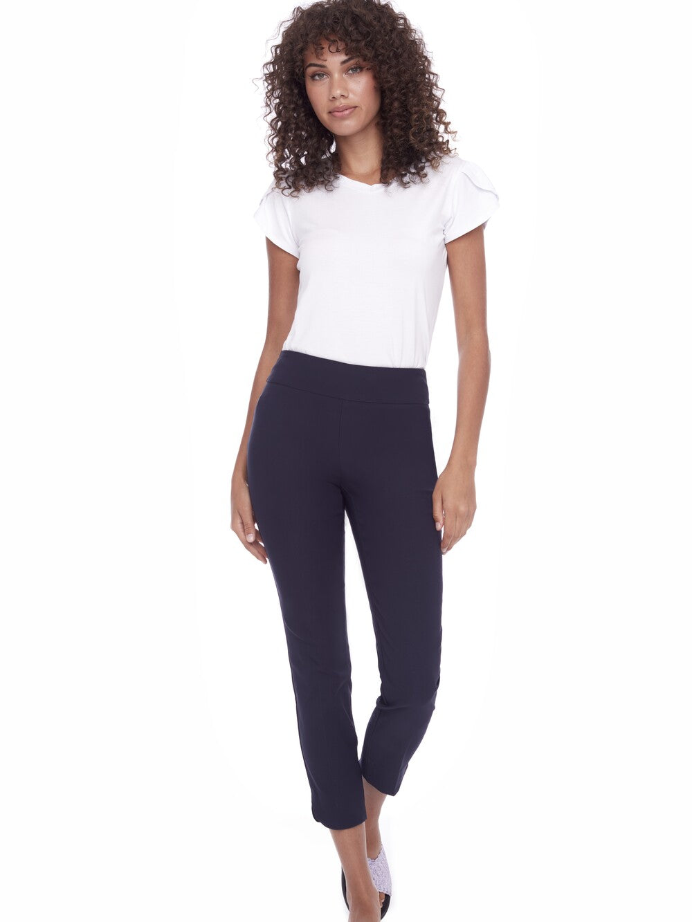 Model dressed in UP Solid Wrap 28" Petal Slim Pant by Up in navy, paired with a simple white top