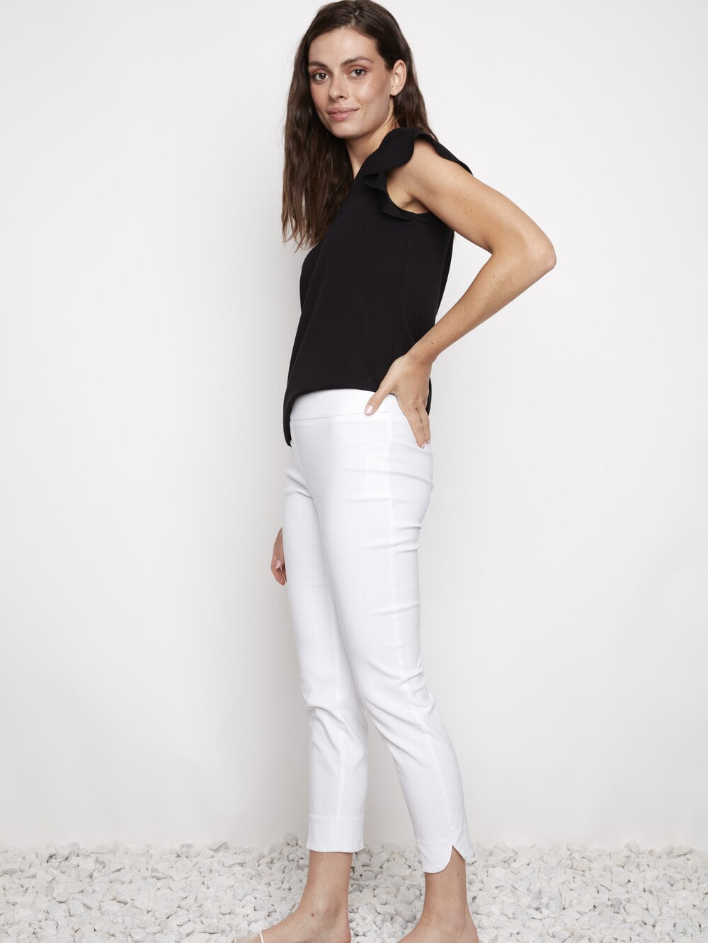 Model wearing white UP Solid Wrap 28" Petal Slim Pant by Up with black sleeveless top against white background