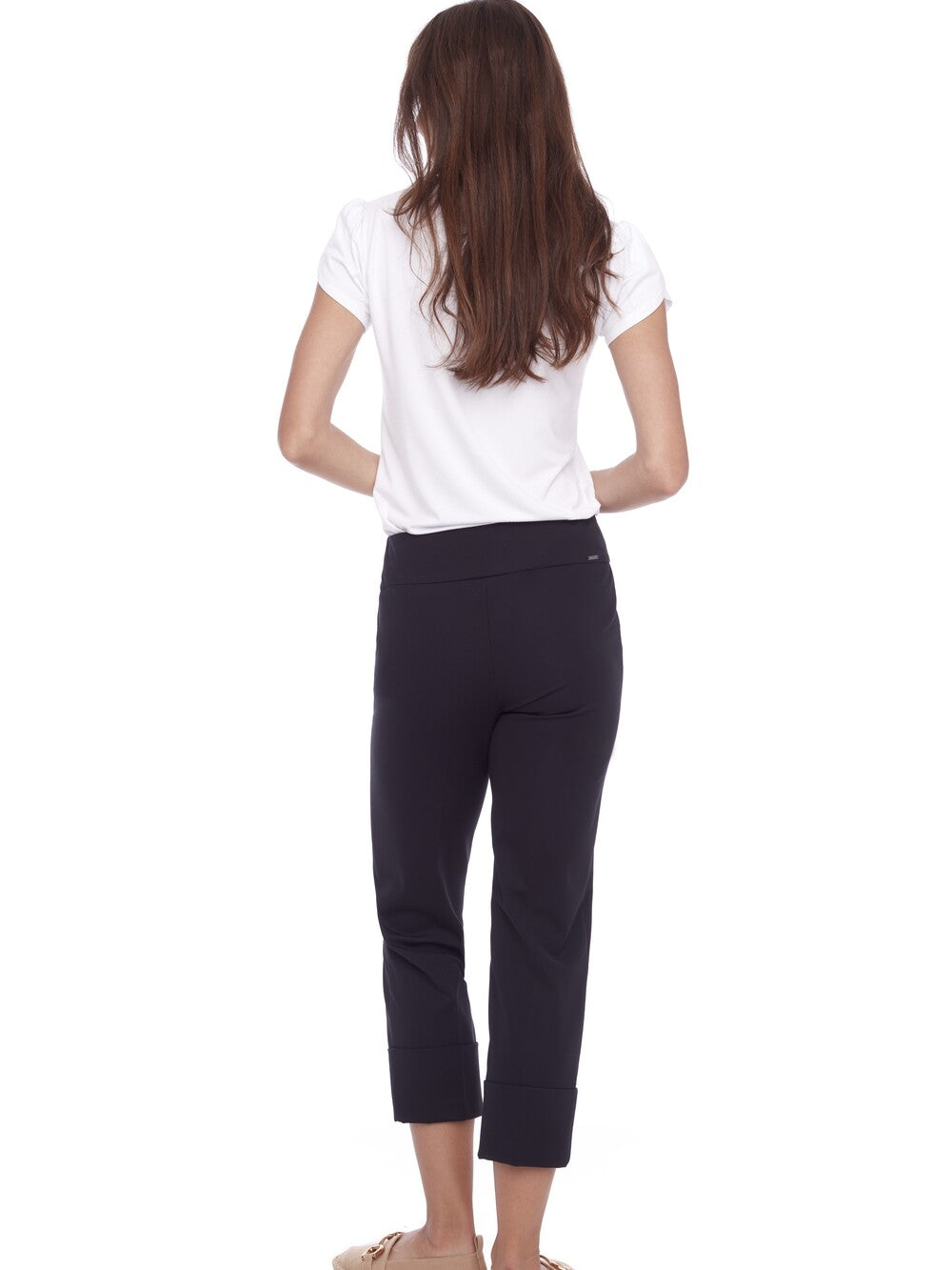 Back view of a person wearing black UP Cool Compression 25" Deep Cuff Pant by Up with a white t-shirt