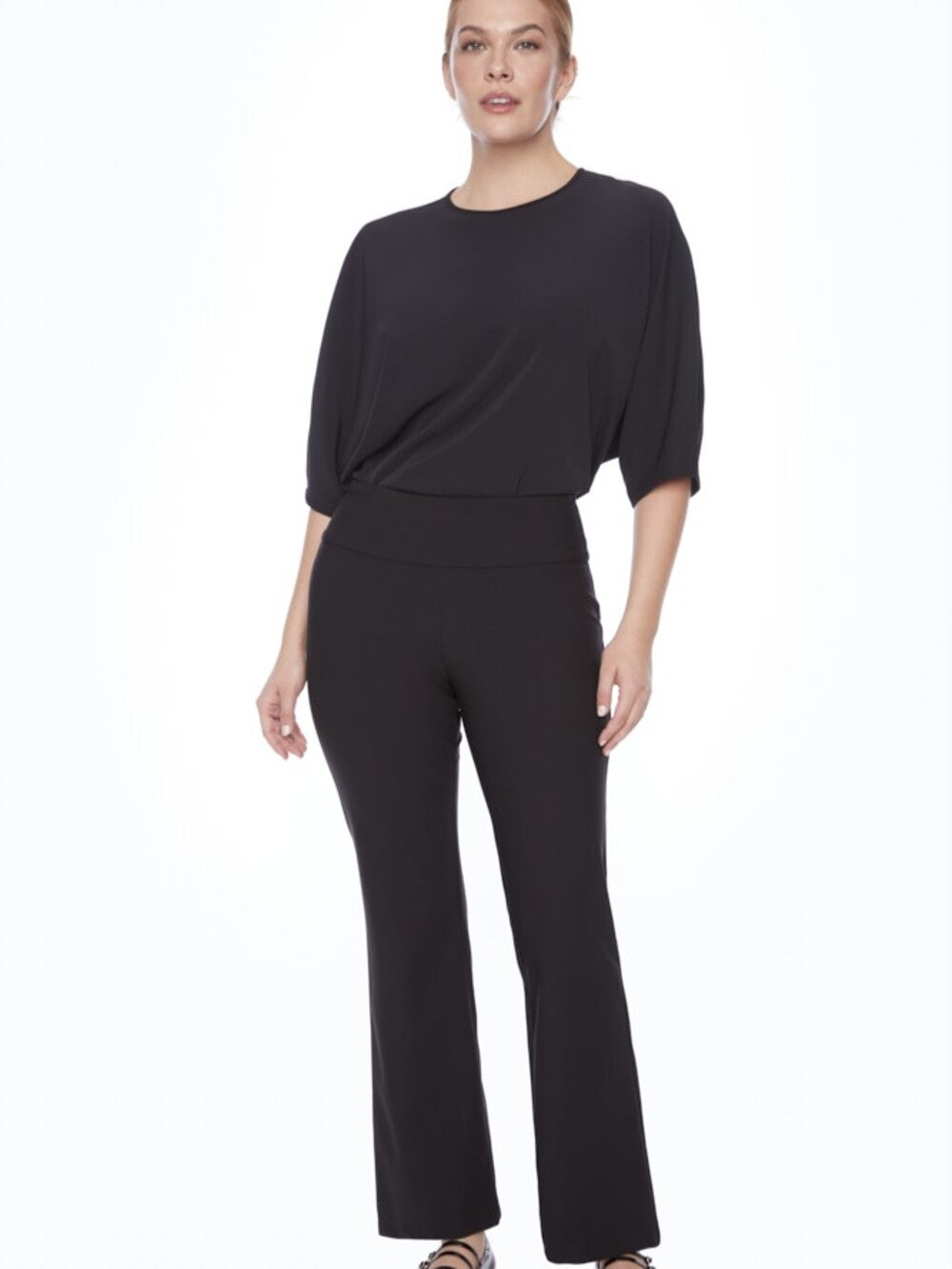 Slim fit black pants styled with a black top, featuring the UP Precision Ponte Slim Boot 31" Pant by Up.