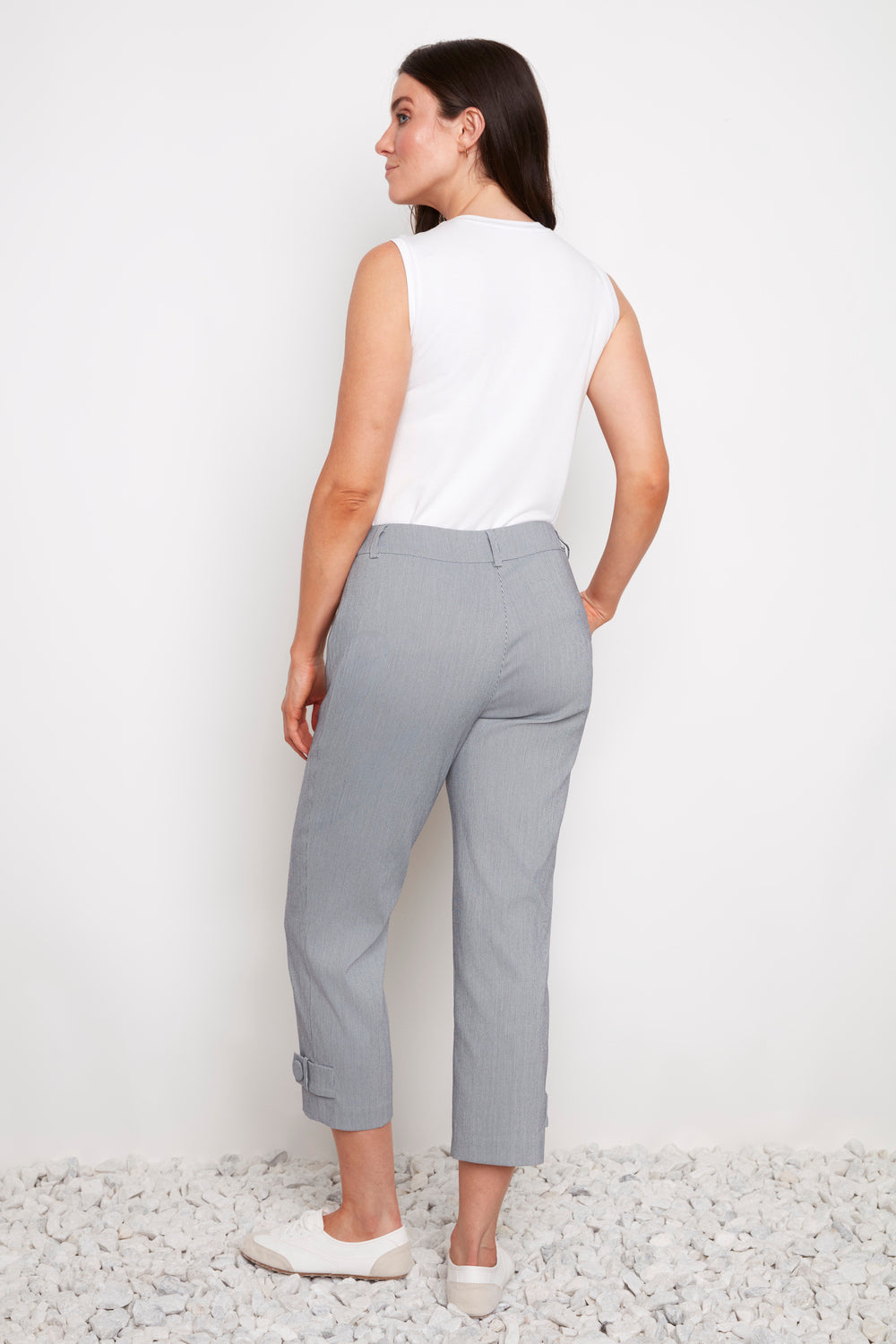 Back view of UP Techno Stripe 25" Tab Button Crop Pant in light grey by Up, styled with white sleeveless top and shoes.