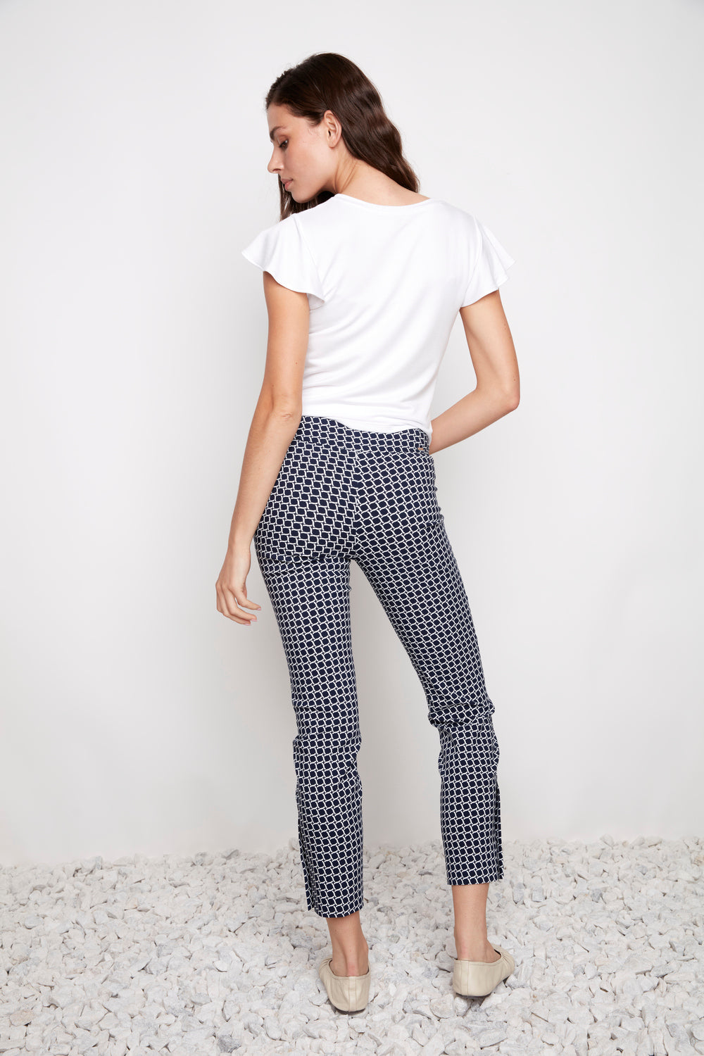 Up Coastal Techno 28" Button Hem Pant in navy geometric pattern by Up, styled with a white top and beige shoes.