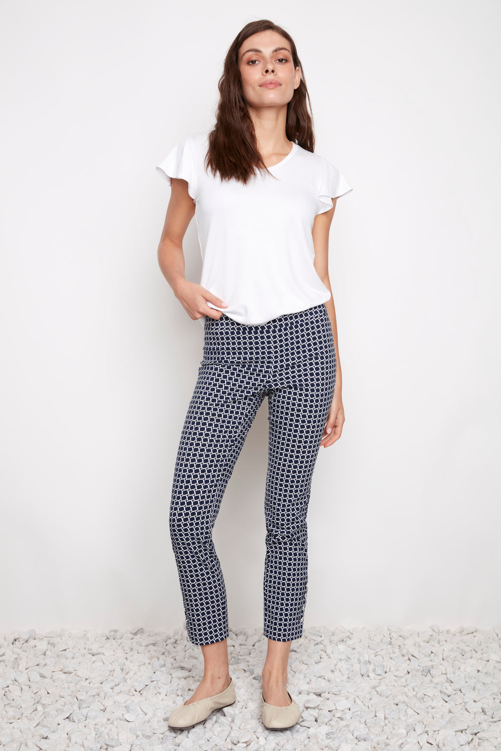 Slim fit navy patterned UP Coastal Techno 28" Button Hem Pant by Up styled with a white short sleeve top and flats