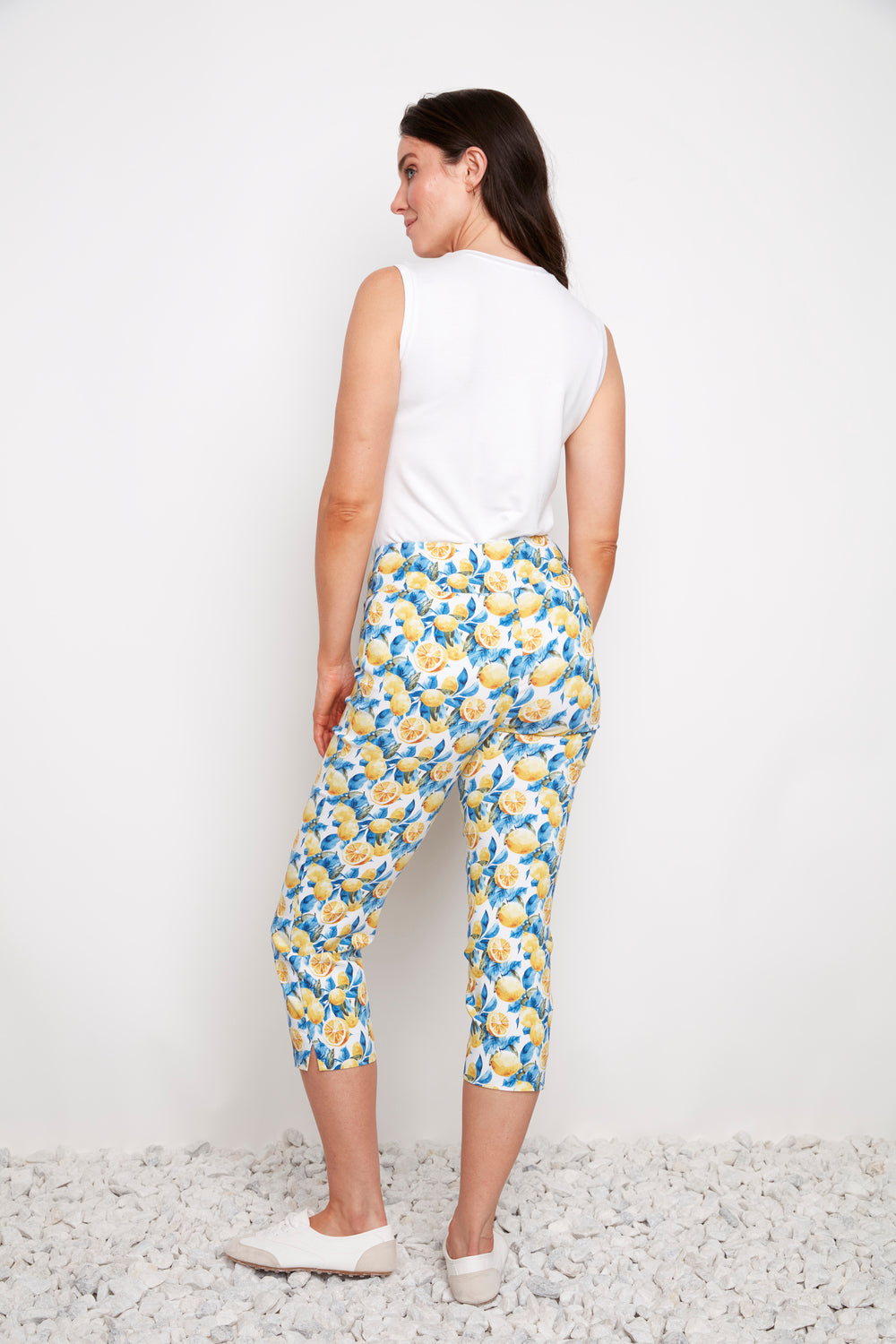 Up Techno Lemon 23" Side Slit Crop Pant by Up in lemon print worn with white sleeveless top and casual shoes
