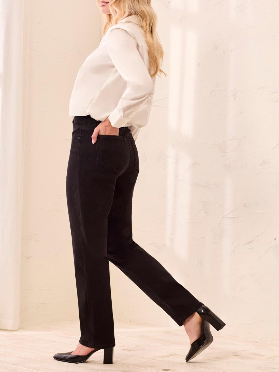 Black denim Tribal Sophia Curvy Straight Leg Jeans styled with white blouse and black heels by Tribal Sportswear Inc.