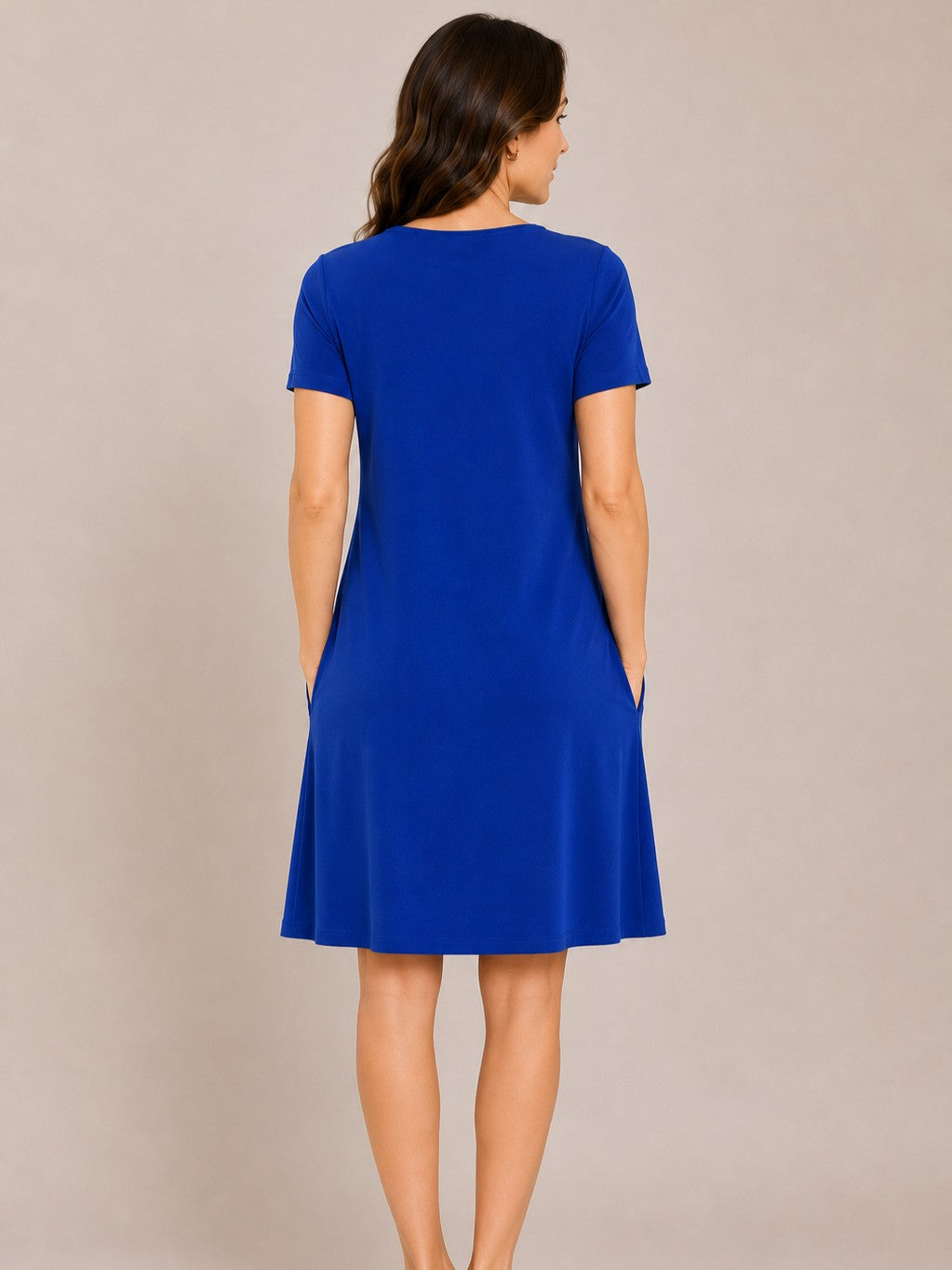 Back view of a royal blue short-sleeve knee-length dress with a relaxed fit on a neutral background.