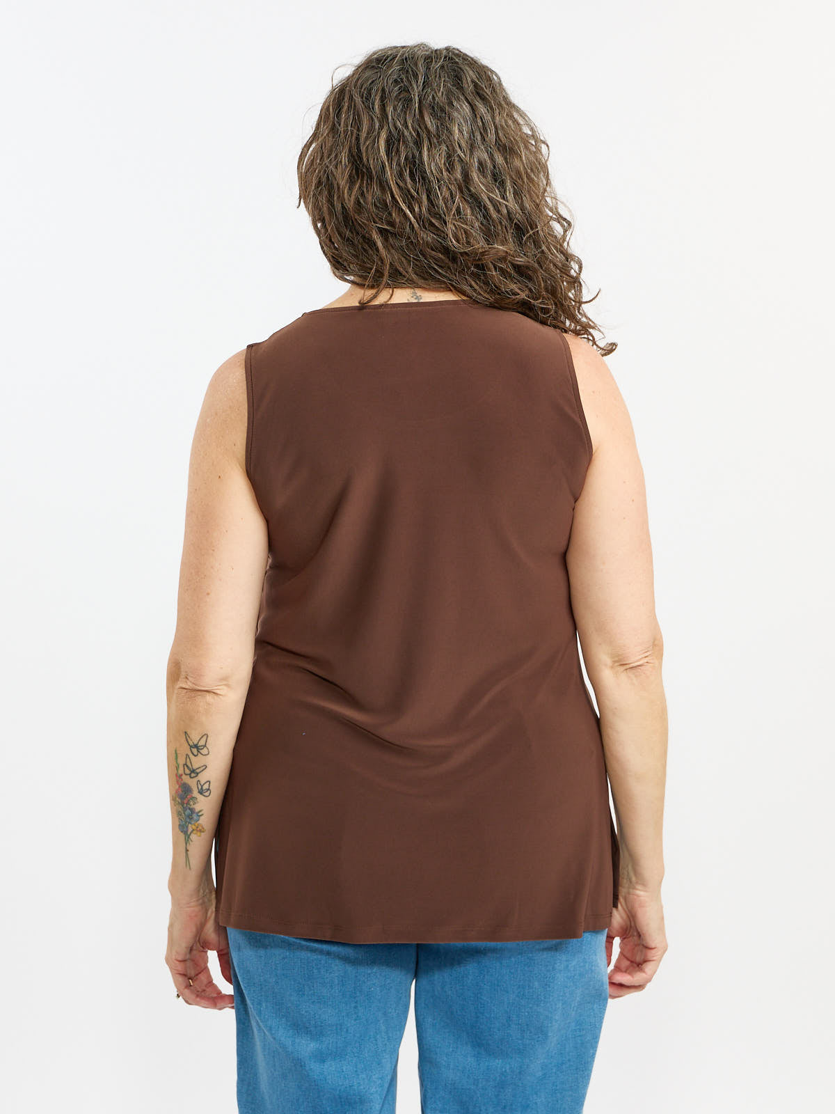 Back view of brown Liz Sleeveless Tank Side Slit Top by Bali Corp. paired with blue denim jeans.