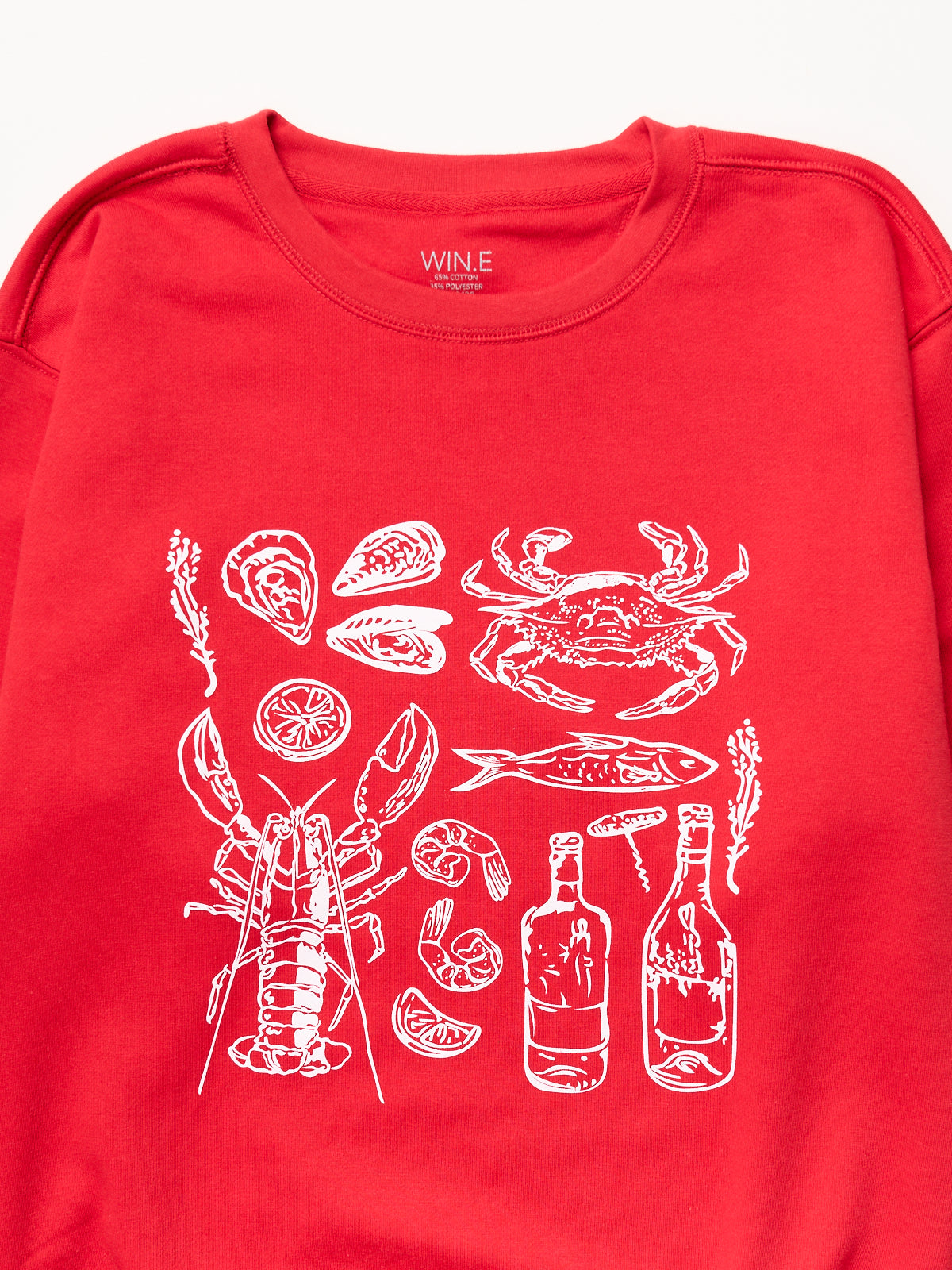 Red sweatshirt with white line art of seafood including crab, lobster, fish, oysters, shrimp, lemon, and bottles.