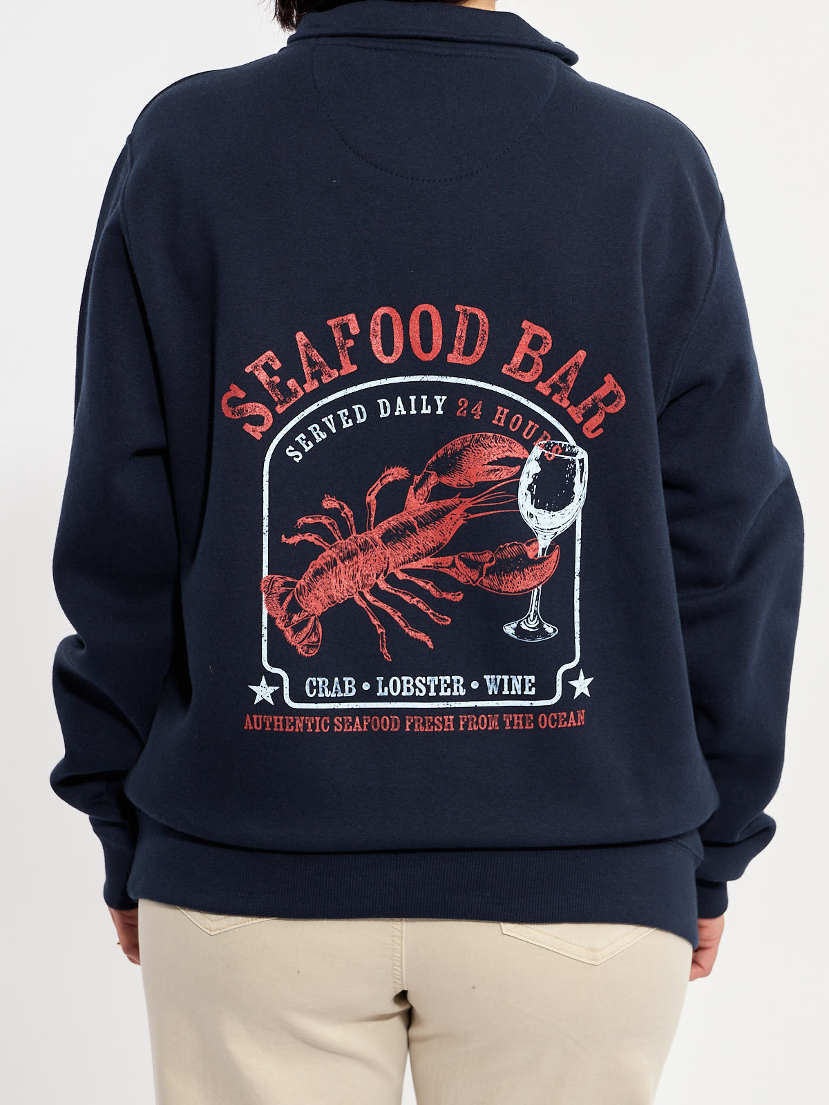 Navy sweatshirt with red graphic of lobster, wine glass, and text about seafood bar on the back